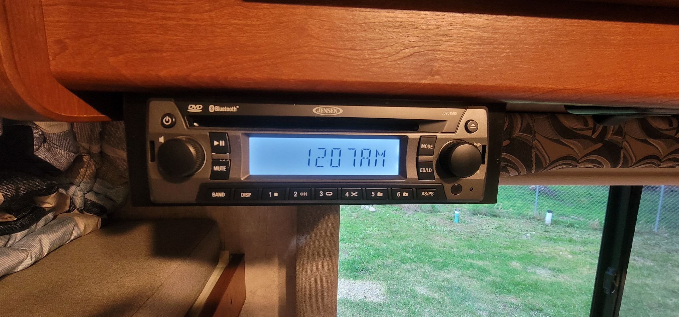 A Jensen JVD1500 stereo/DVD player, with Bluetooth, mounted in an RV rental, displaying "1207 AM".. Winnebago Minnie Winnie 2016
