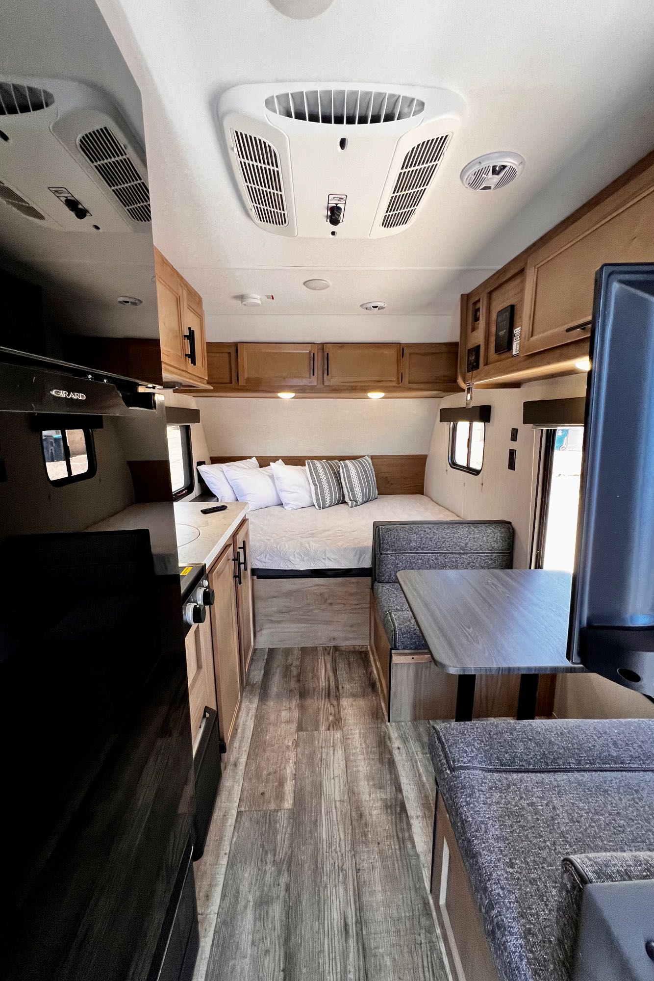 Step inside this RV rental featuring a comfortable bed, full kitchen, dinette, and AC unit. Your cozy adventure awaits!. Forest River Cherokee Wolf Pup 2023