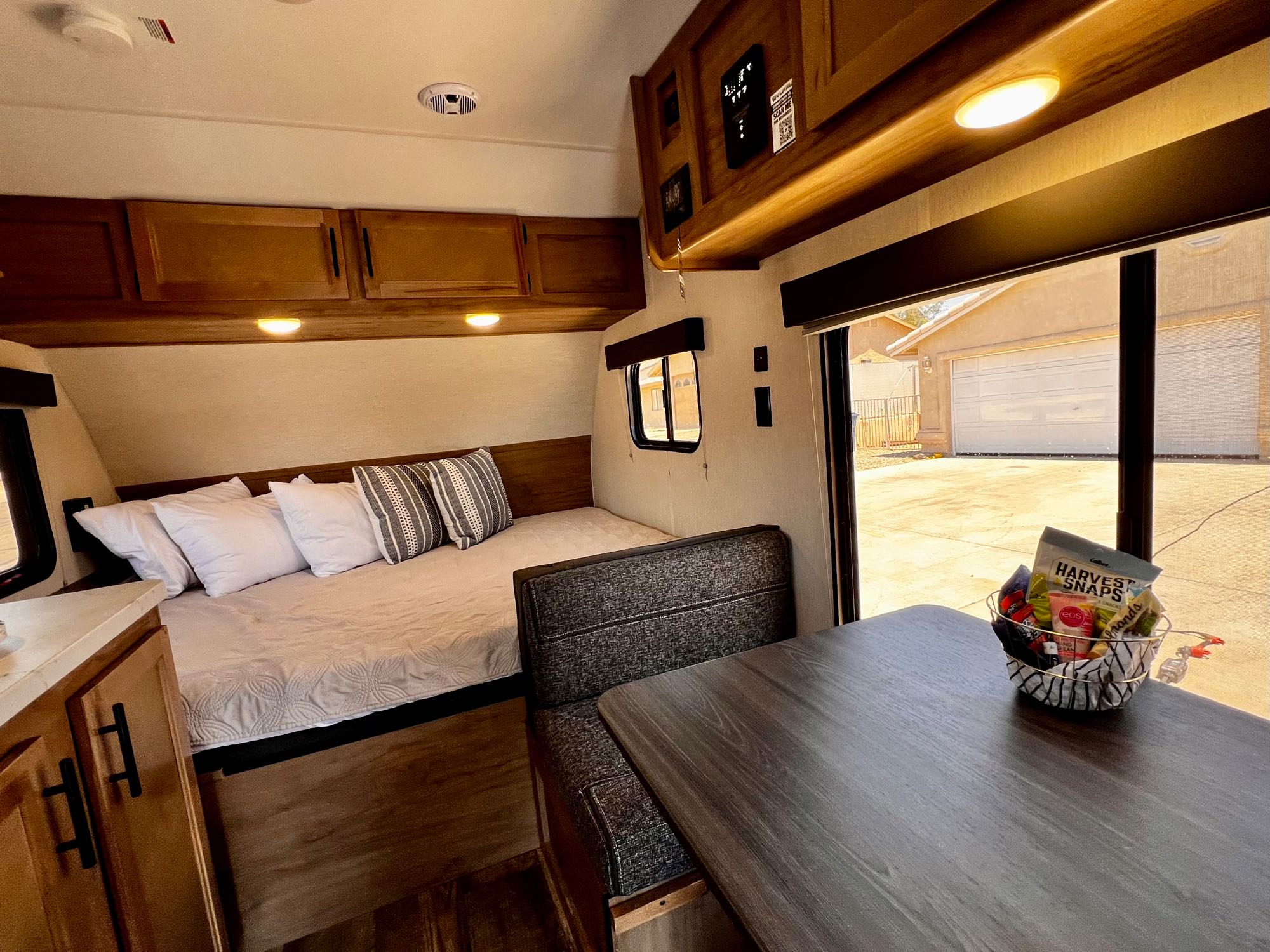 Explore this cozy RV rental interior, featuring a comfortable bed, dining area, and practical amenities for your next adventure.. Forest River Cherokee Wolf Pup 2023