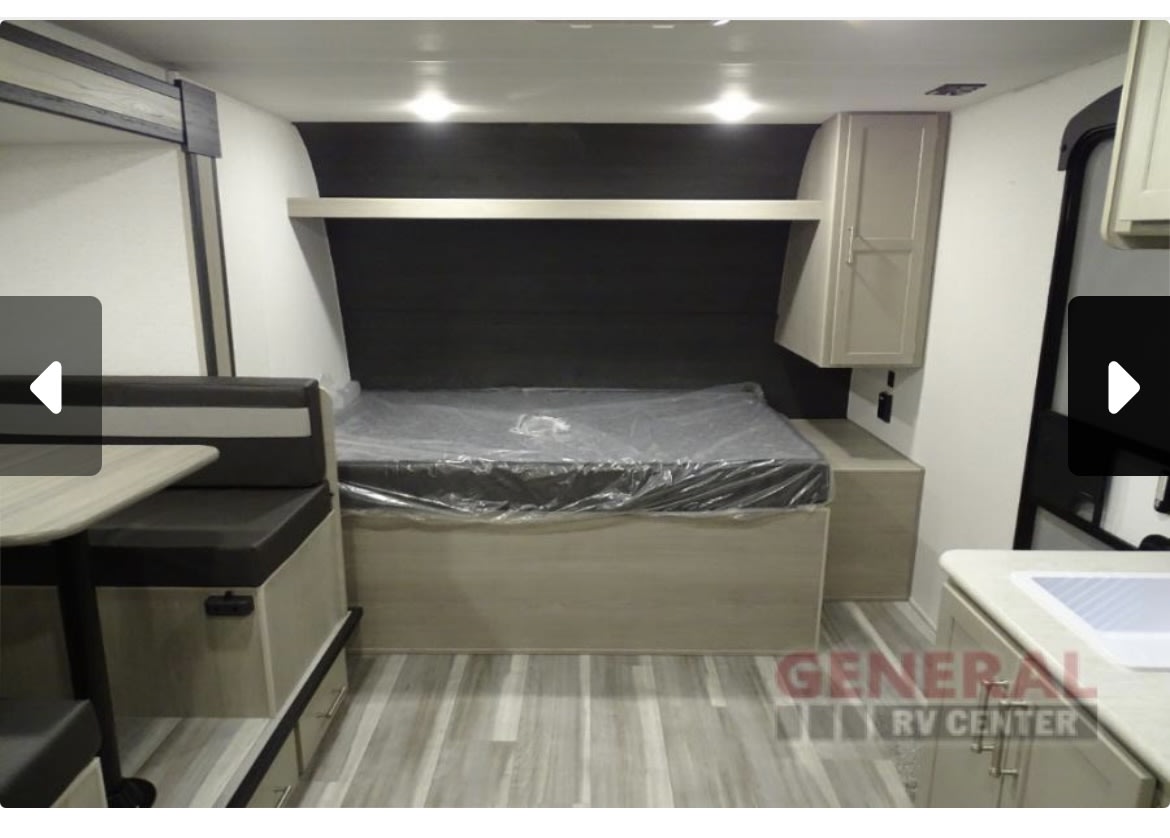 RV rental interior: features a new bed, dinette, and kitchenette, ready for travel.. Keystone RV Springdale 2024