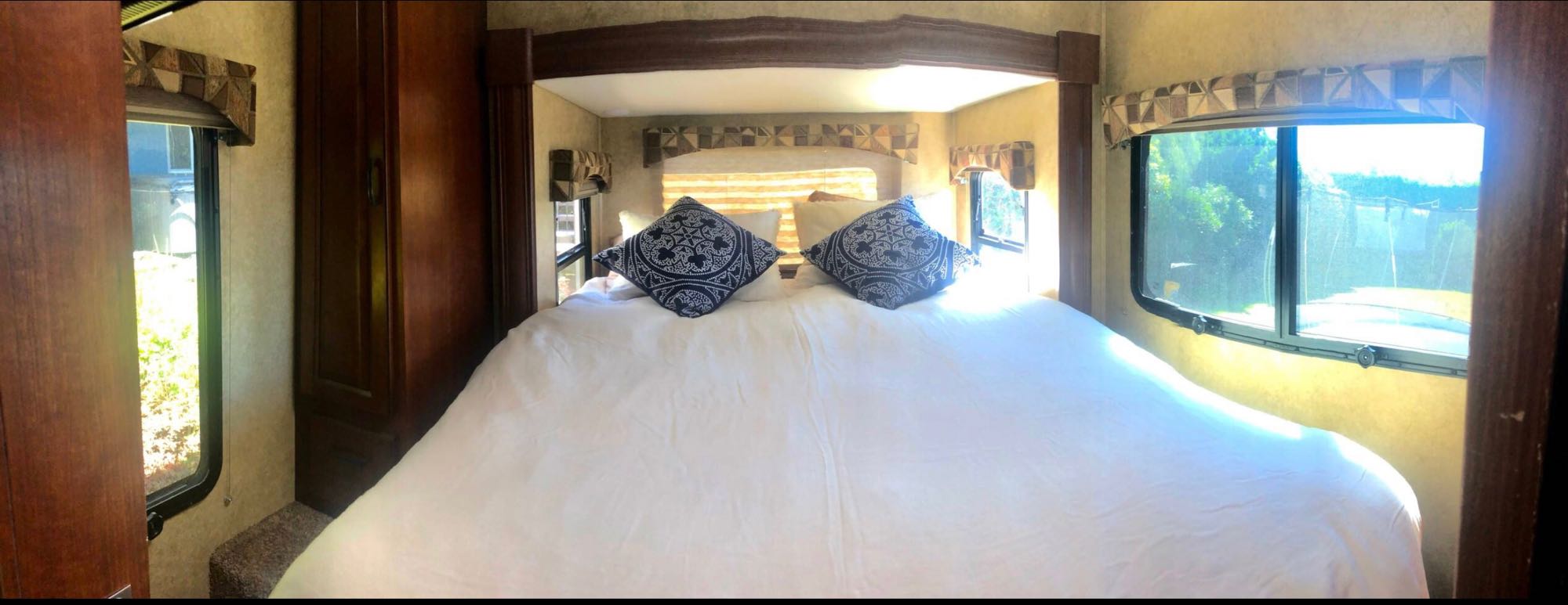 The “bedroom” includes a regular size queen bed that extends out back as a rear slide. There is minimal walk around room.. Forest River Solera 24R 2013