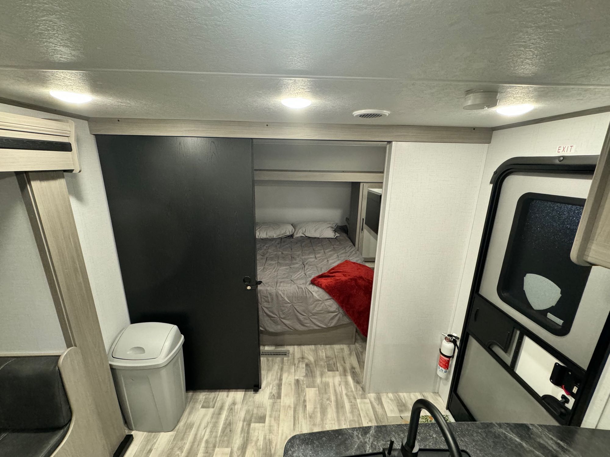 Inside a modern RV rental, with a cozy bedroom, compact kitchen, and living area. A functional travel camper.. Dutchmen Kodiak SE 2024