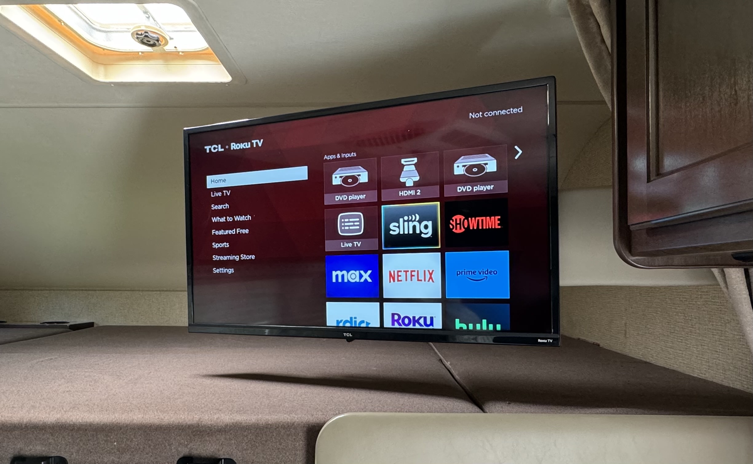 RV rental interior featuring a TCL Roku TV displaying its home screen with streaming apps like Netflix and Prime Video.. Thor Four Winds 2018