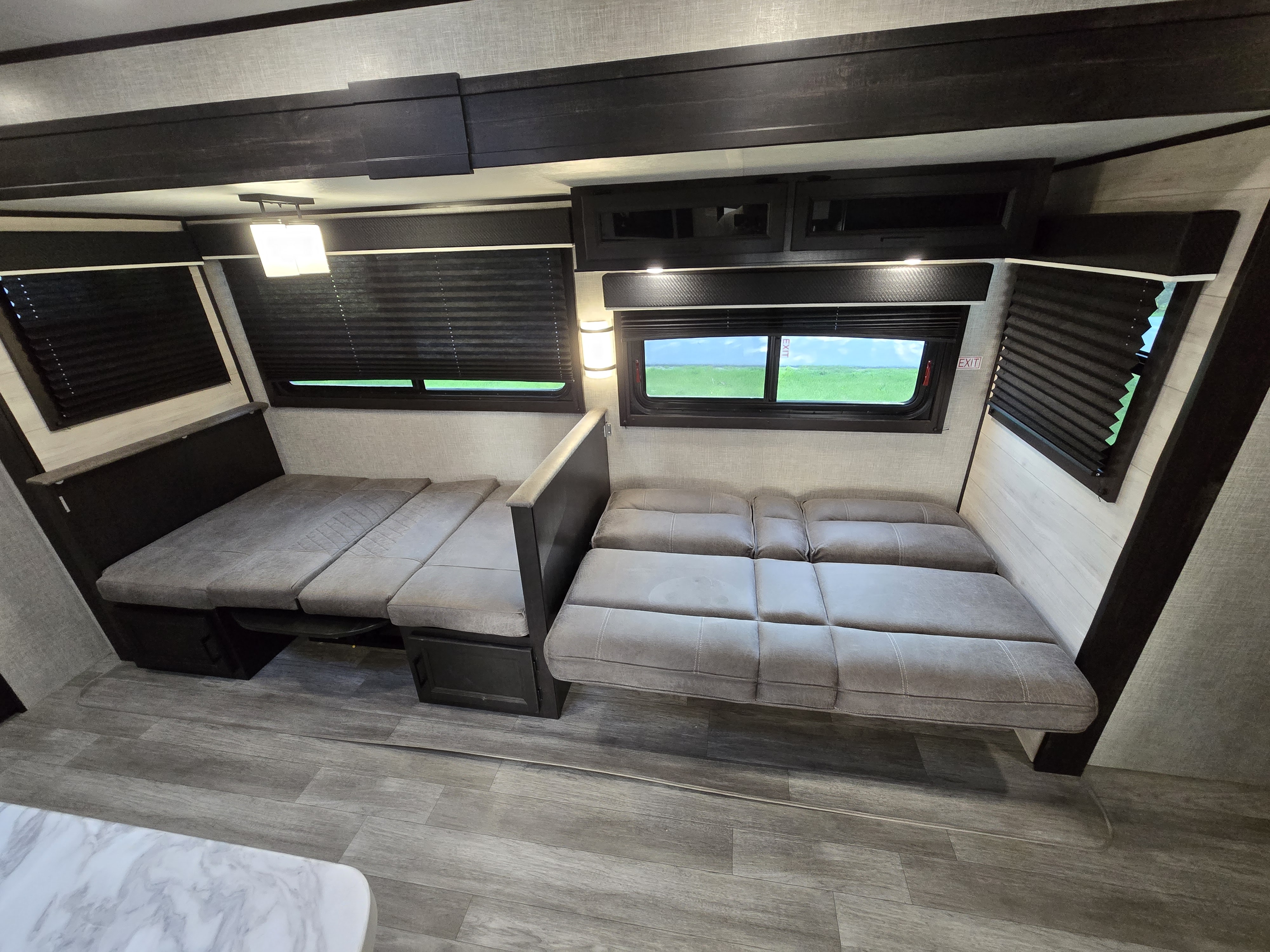 RV rental interior features spacious, convertible seating/bed areas, large windows with views, and modern storage for comfortable travel.. Jayco Jay Flight 2022