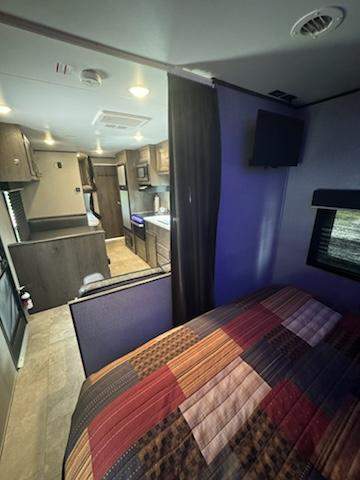 Spacious RV rental interior featuring a cozy bedroom, full kitchen, and living area, perfect for comfortable travel adventures.. Jayco Jay Flight SLX 2020