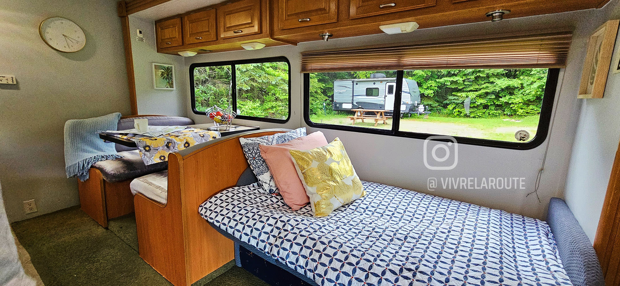 Spacious RV rental interior featuring a cozy dinette, comfortable bed, and scenic window views of nature. Perfect for camping!. Coachmen Freelander Deluxe/Premier 2005