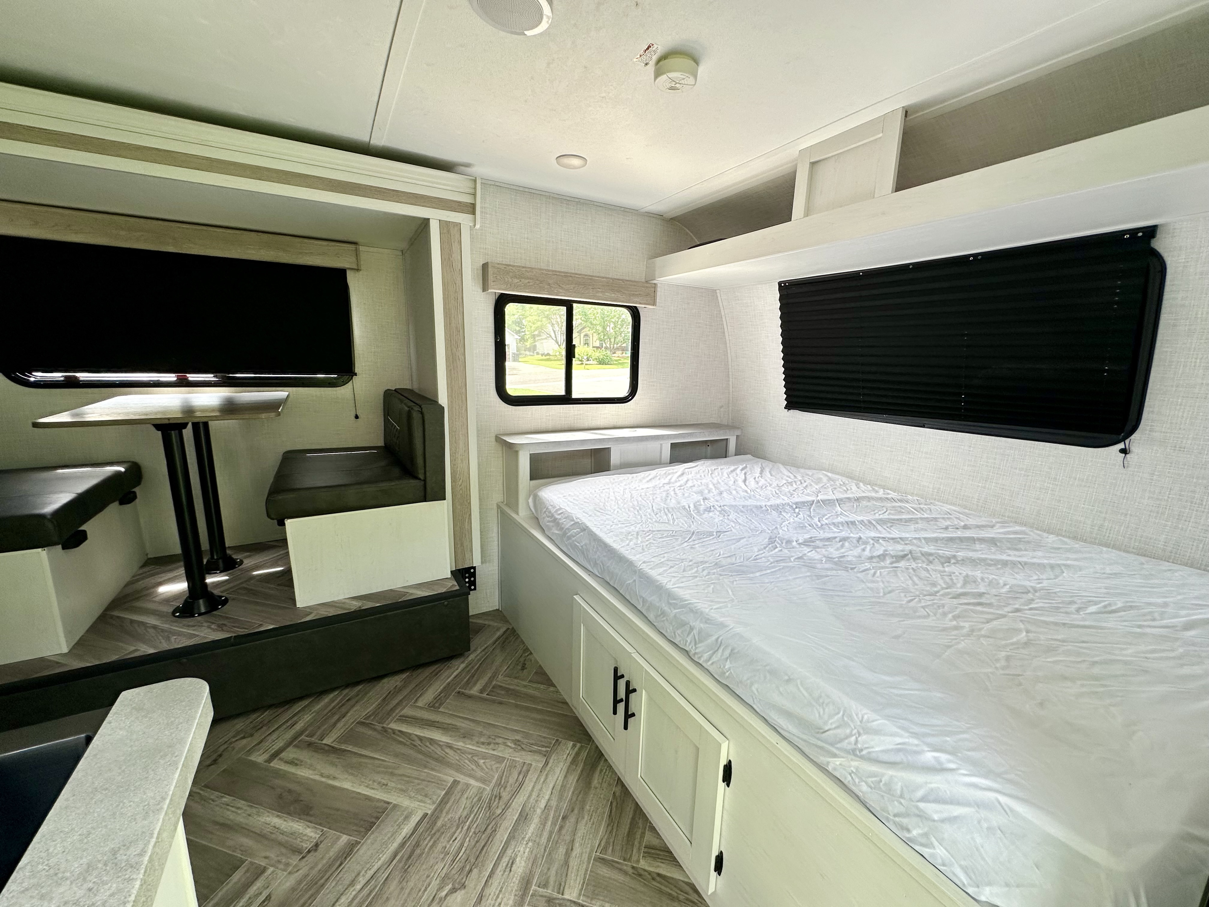 Spacious RV rental interior featuring a cozy bedroom with storage and a functional dinette, perfect for your next adventure.. Dutchmen Coleman Rubicon 2023