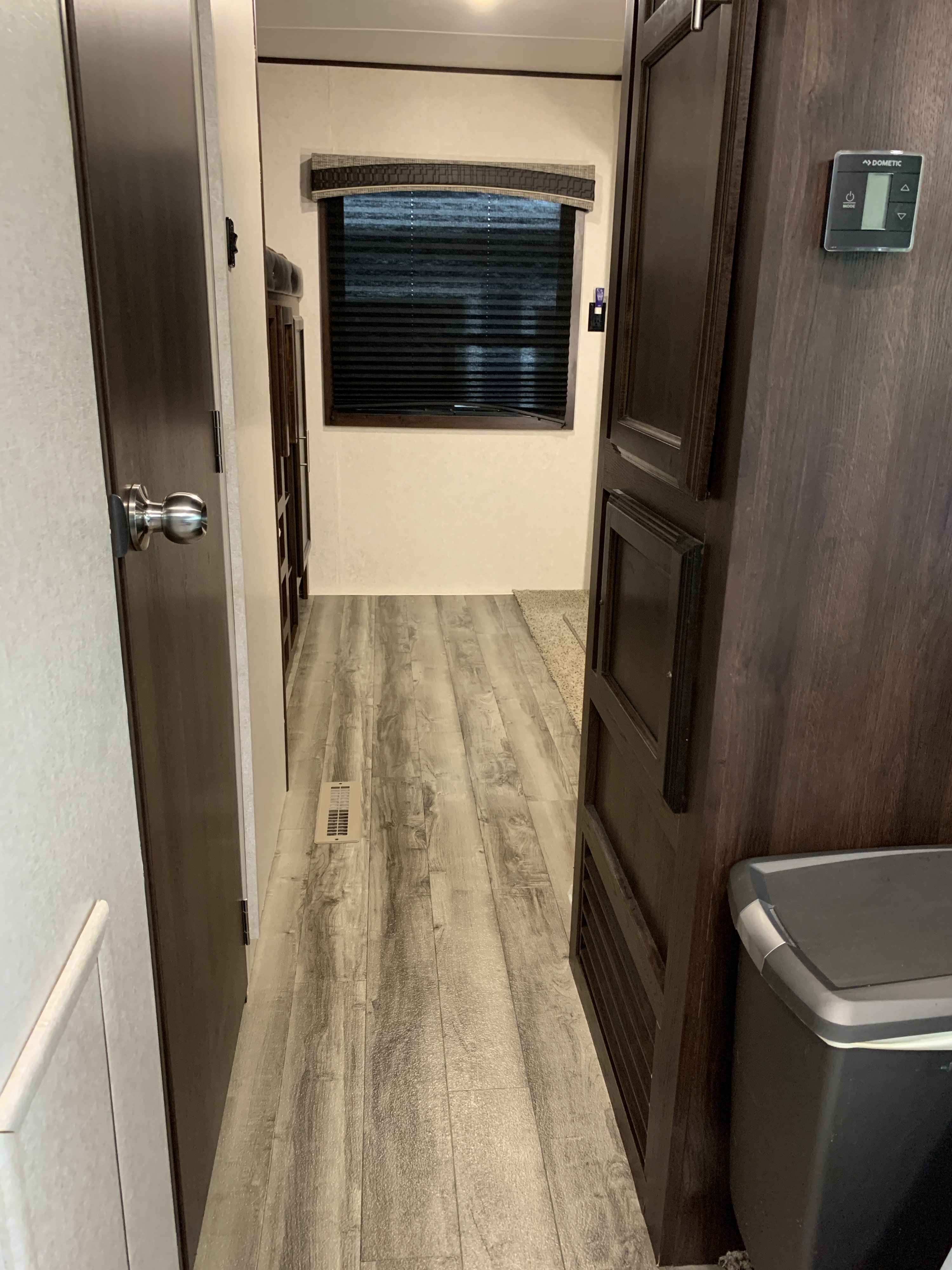 Perfect for your next rv rental! This RV's interior hallway includes wood-look flooring, a bright window, and a Dometic thermostat.. Jayco Jay Flight 2019