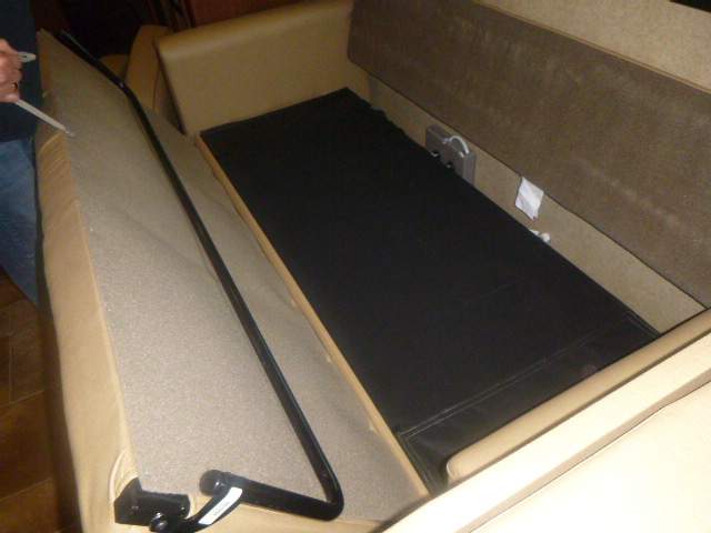 RV rental: Convertible sofa bed open, showing the lifted base and internal storage space.. Thor Hurricane 2015