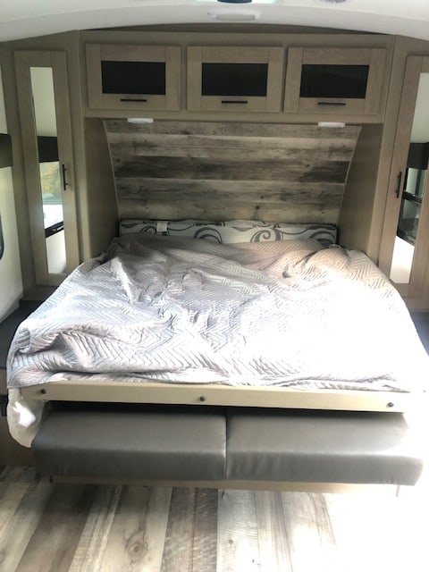 RV rental bedroom with a space-saving murphy bed over seating, ample overhead storage, and mirrored closets.. Heartland RVs Other 2022