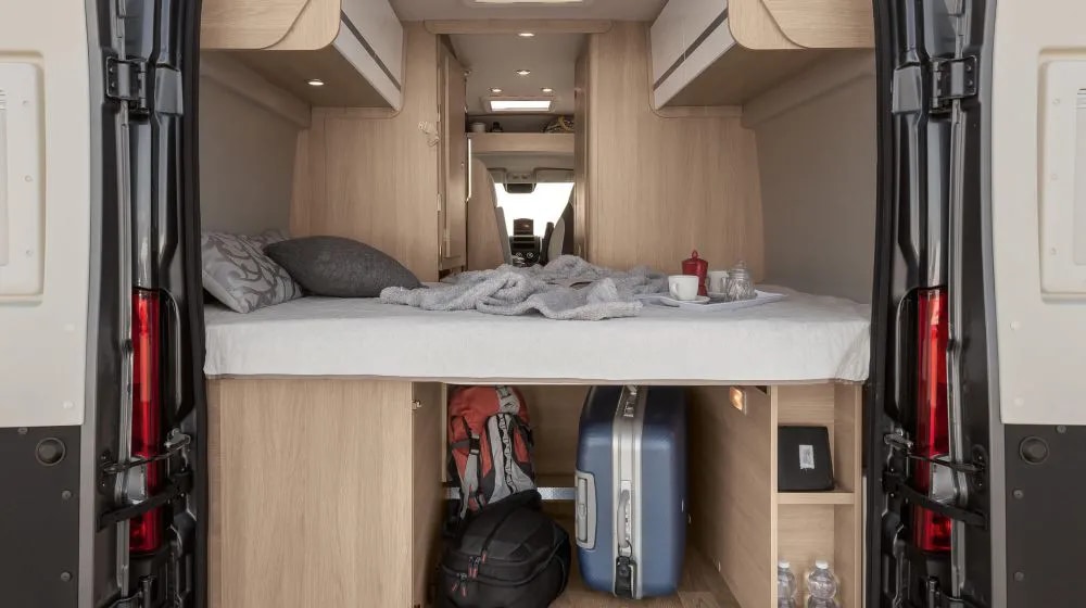 This RV rental offers a comfy bed with under-bed storage for bags & gear. A tray with coffee sets the scene for your road trip.. Giottivan 60T 2024