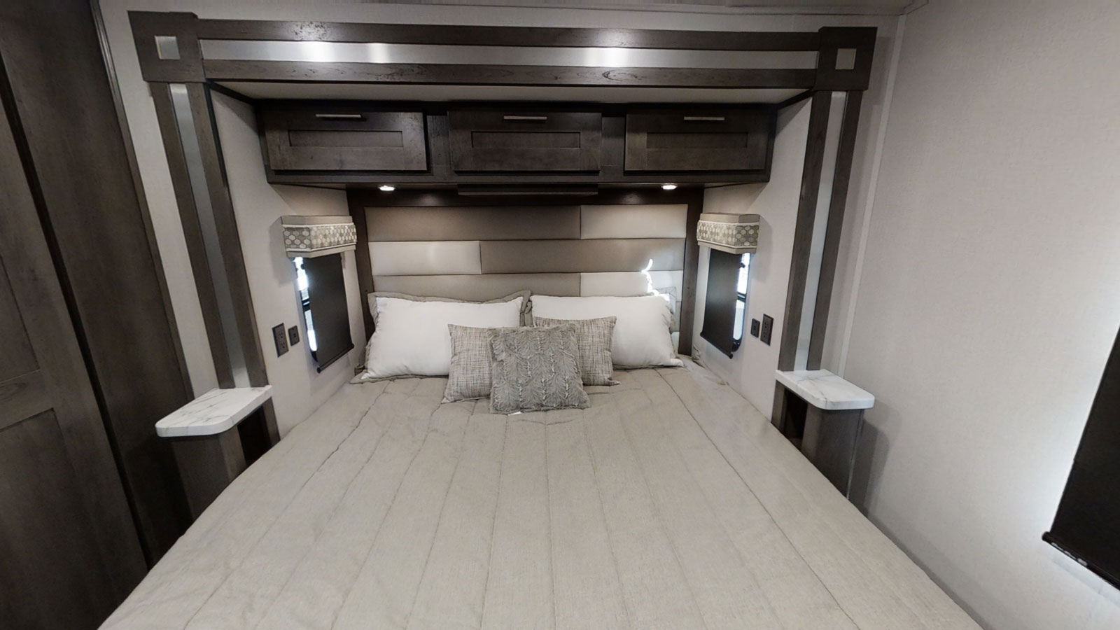 RV rental bedroom showcasing a modern bed, overhead storage, and integrated nightstands.. Forest River gt5 2021