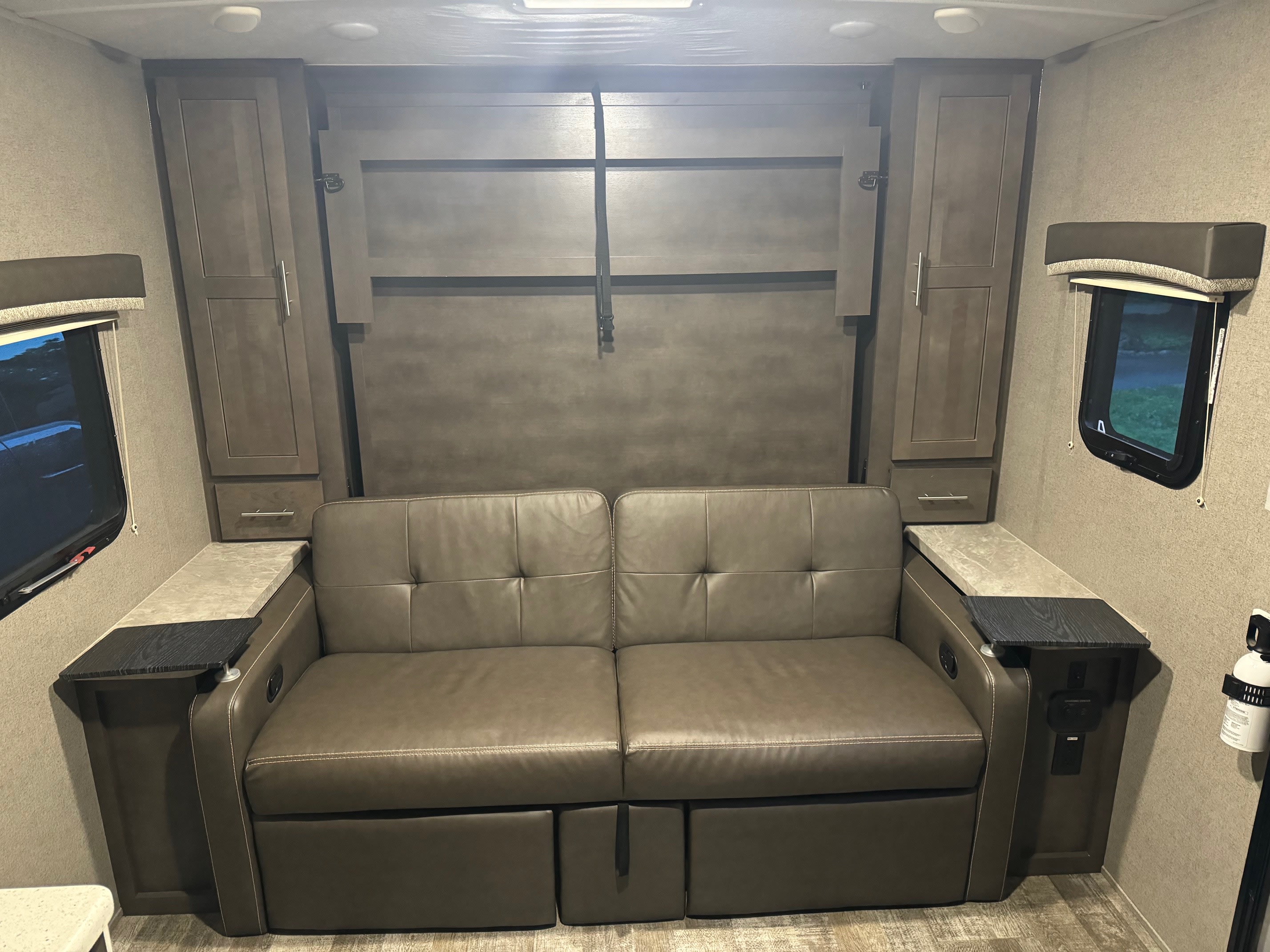 Spacious RV rental interior featuring a comfortable sofa, convertible to a bed, ample storage, and convenient charging.. Forest River Rockwood Mini Lite 2020