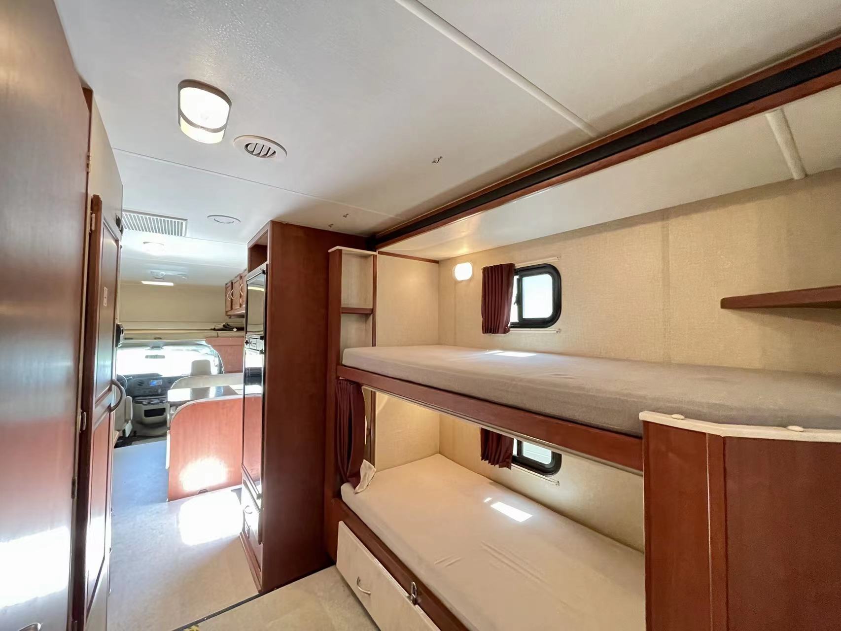 Spacious RV rental interior featuring comfortable bunk beds, ideal for family travel.. Itasca Spirit 2015