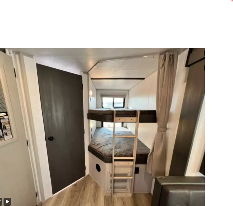 RV rental interior features a functional bunk bed sleeping area with ladder, door, and wood-look flooring.. Forest River Salem Hemisphere HL 2022