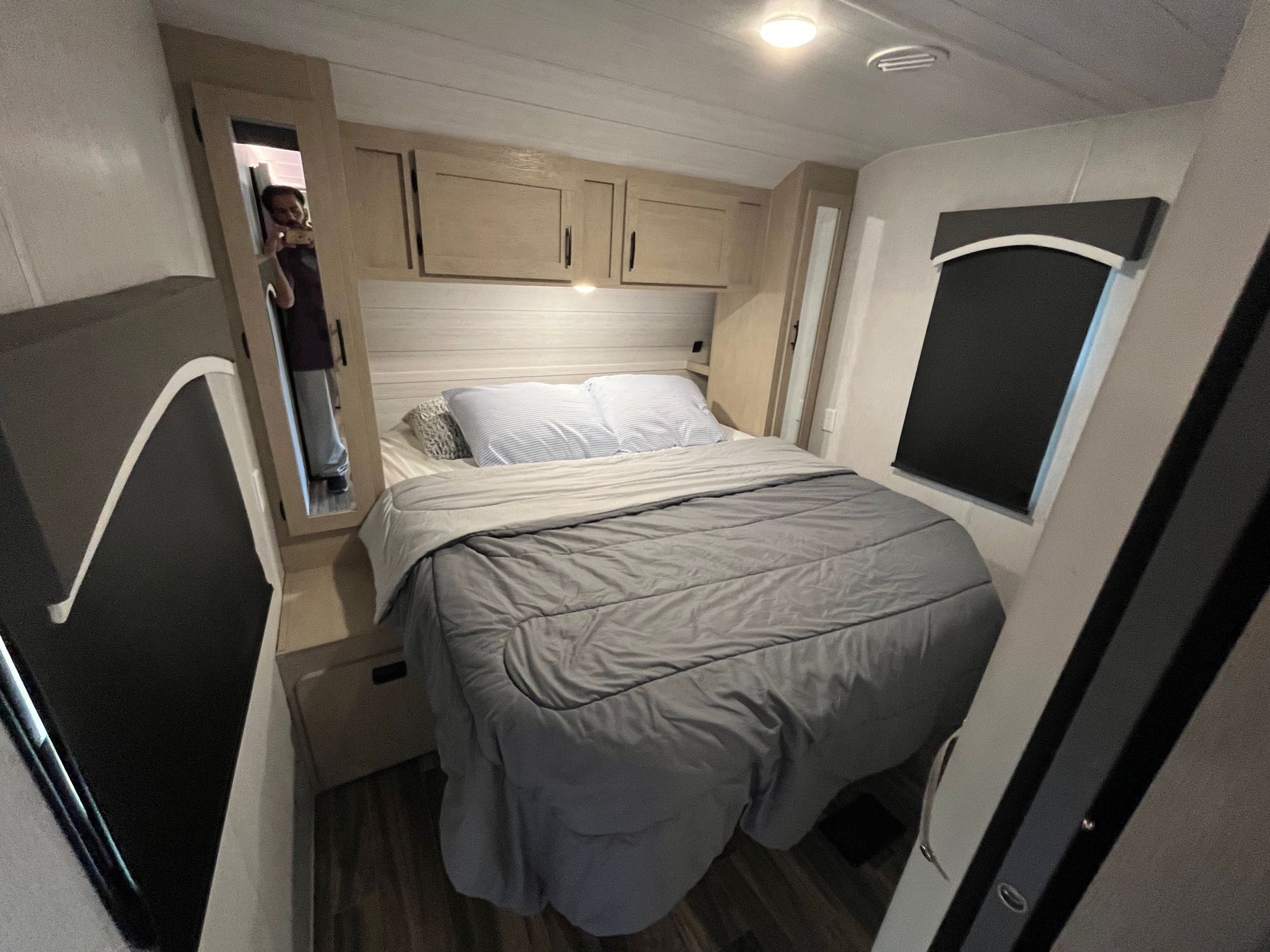 Cozy RV rental bedroom featuring a queen bed, overhead storage, and a privacy window shade.. Forest River Evo 2650 2023