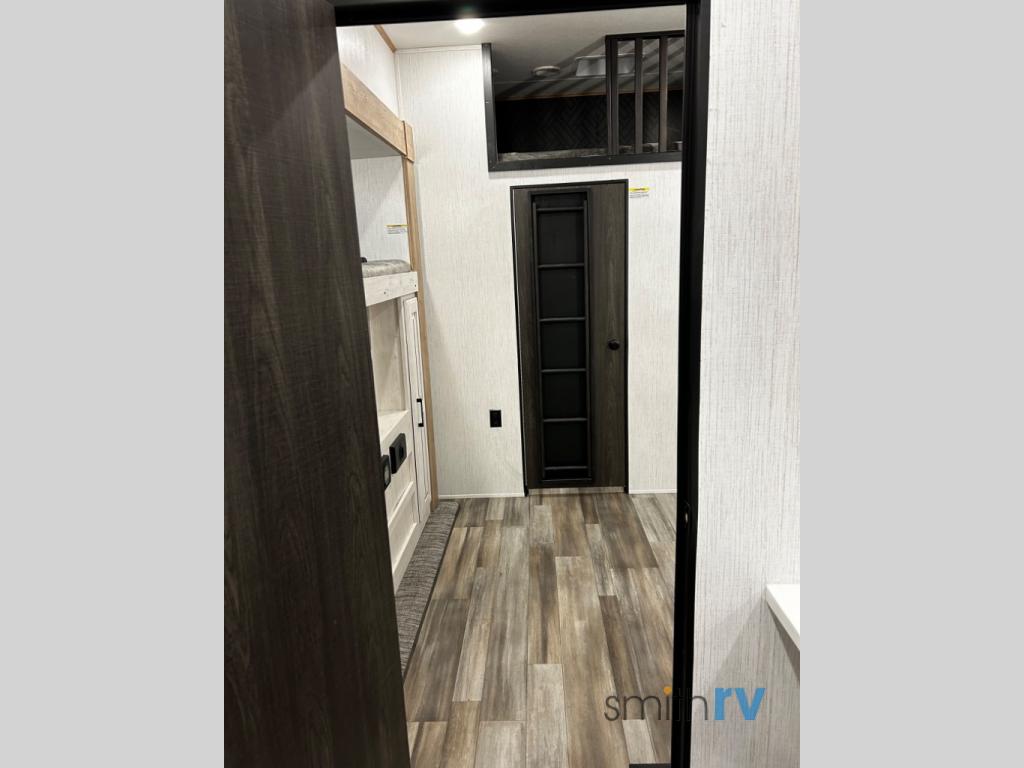 Explore this RV rental's inviting interior with bunk beds, a loft, and modern wood-look flooring. Ideal for comfortable travel.. Heartland Bighorn 2023