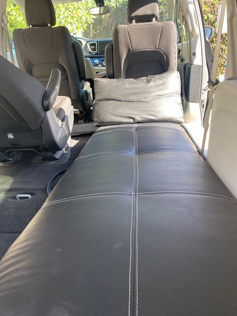 Minivan interior showing a full bed setup, ready for your RV rental adventure or car camping.. Chrysler Other 2020