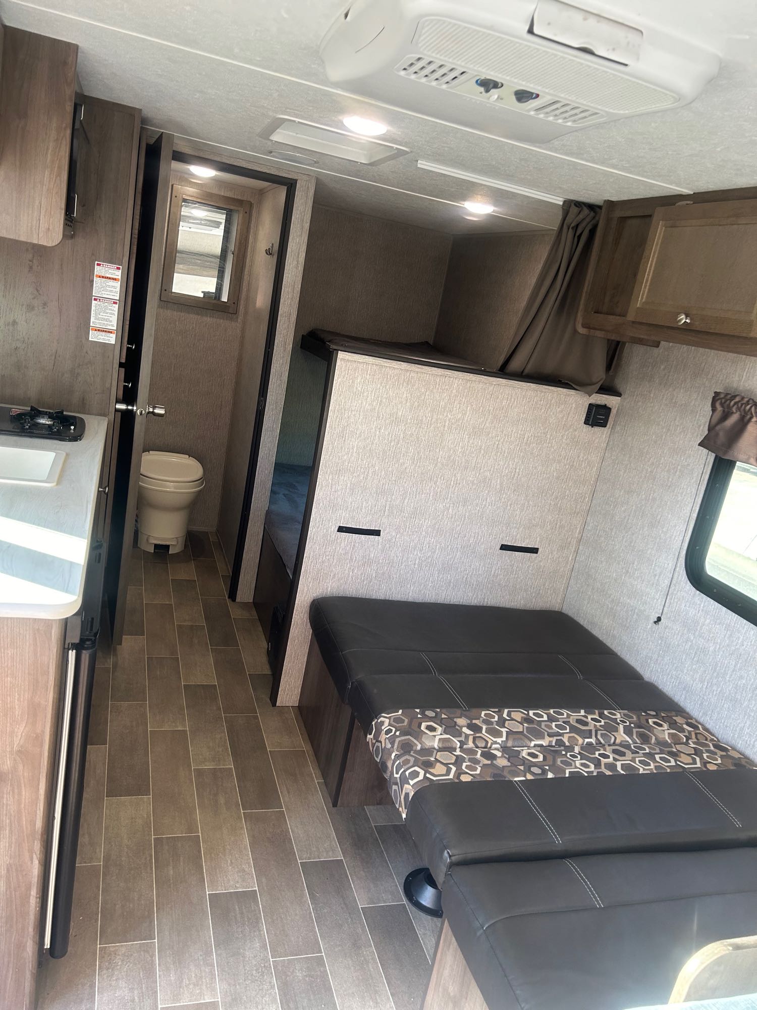 Explore this rv rental's interior: kitchenette, toilet, bunks, and a convertible dinette bed. Ready for your trip!. Coleman Lantern 17FQ 2020