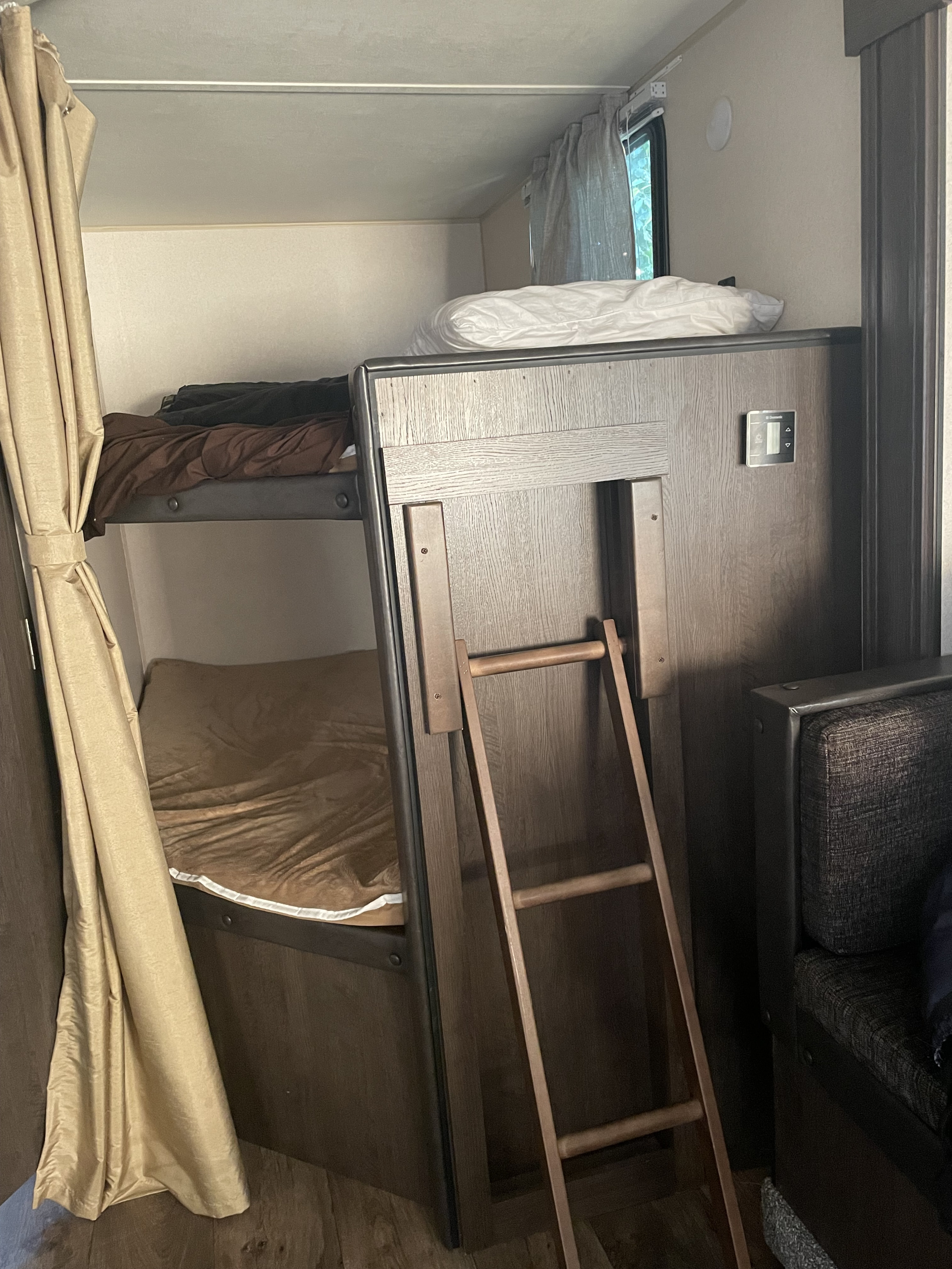 Experience an RV rental: compact bunk beds with ladder, Dometic climate control, and privacy curtains.. Forest River Salem Cruise Lite 2019
