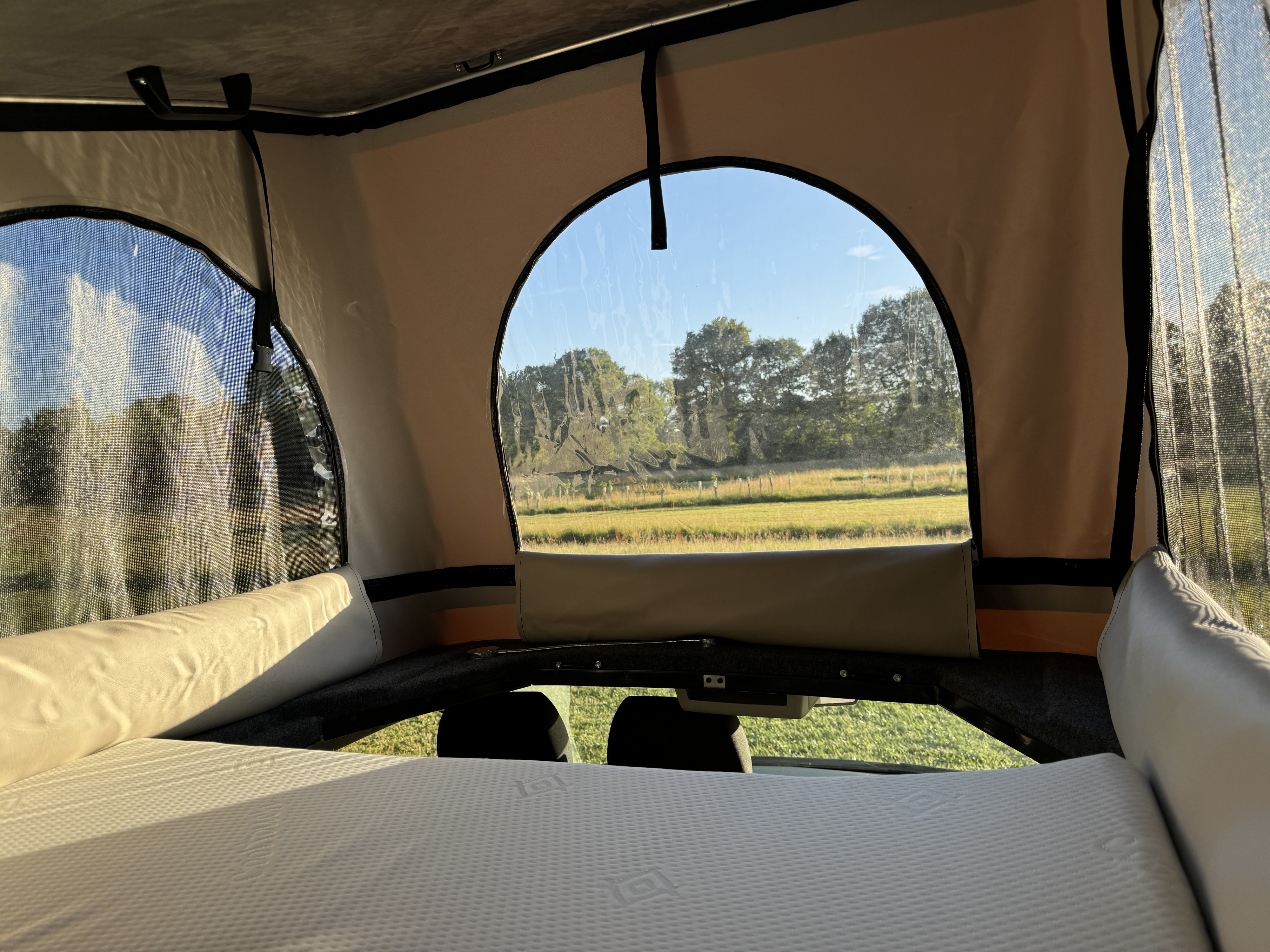 Wake up to nature in this cozy rv rental! Camper sleeping area with mattress, clear views of fields and trees.. Volkswagen T6 transporter 2018