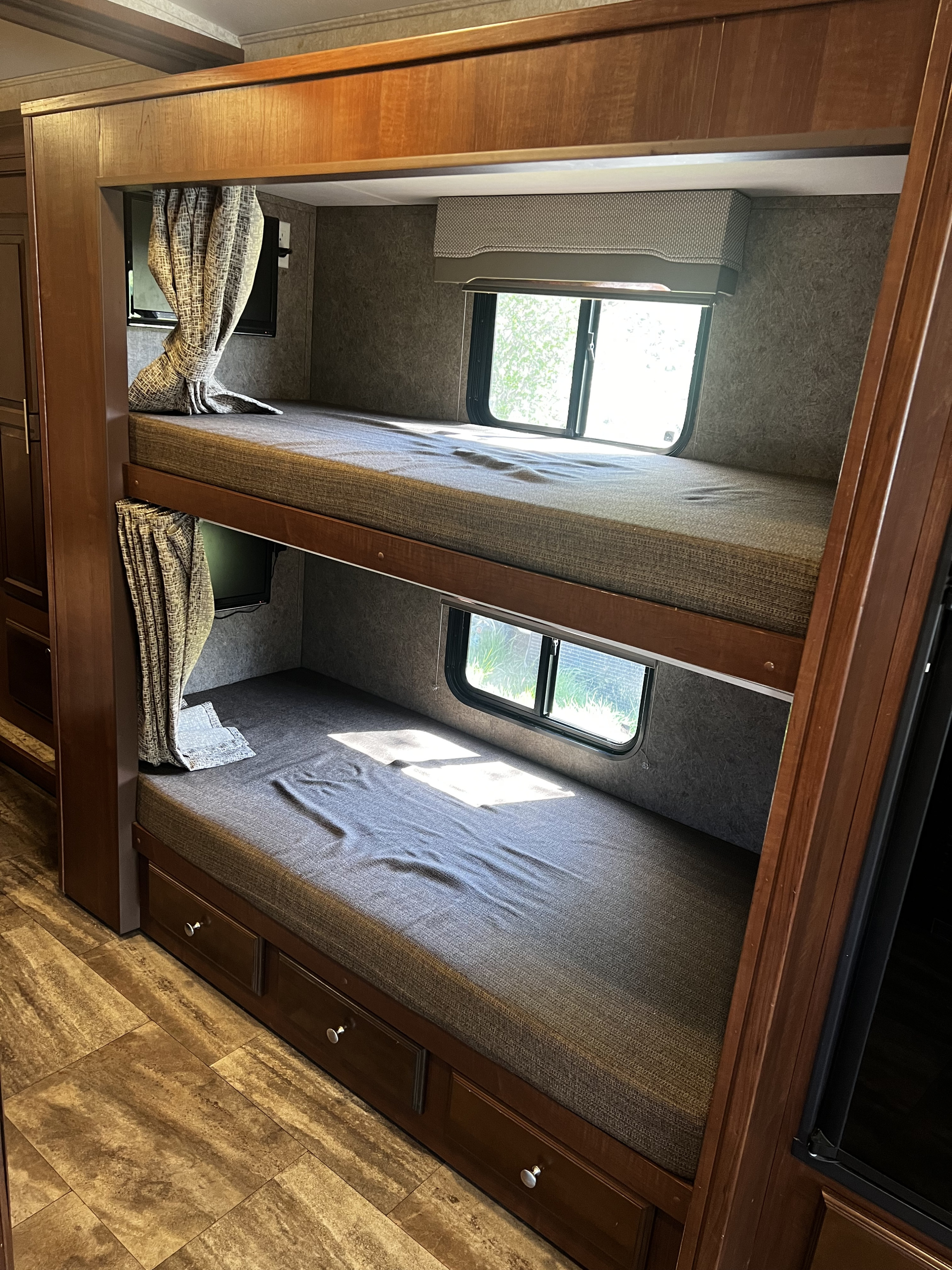 This RV rental offers comfortable bunk beds with windows, personal TVs, and under-bed storage for travelers.. Georgetown GT3 2016