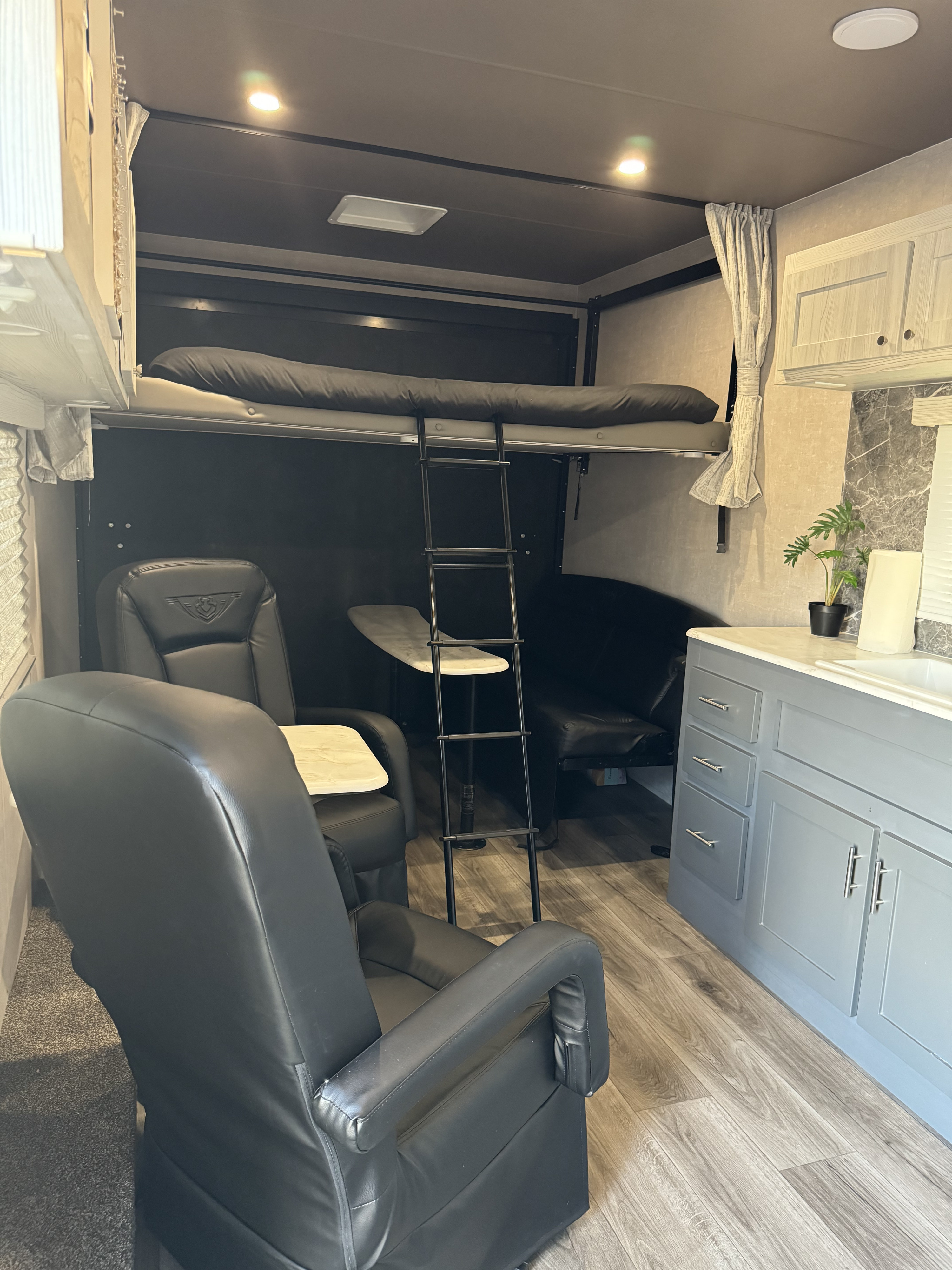 RV rental: Spacious interior with bunk beds, recliners, kitchen, & wood-look flooring.. Eclipse Recreational Vehicles Attitude 2024