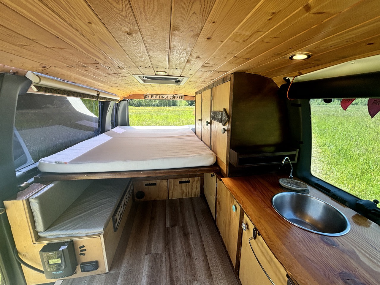 Inside this RV rental: wood-paneled interior, comfy bed, kitchen with sink, and smart storage for your next adventure.. Ford Ford E350 1996