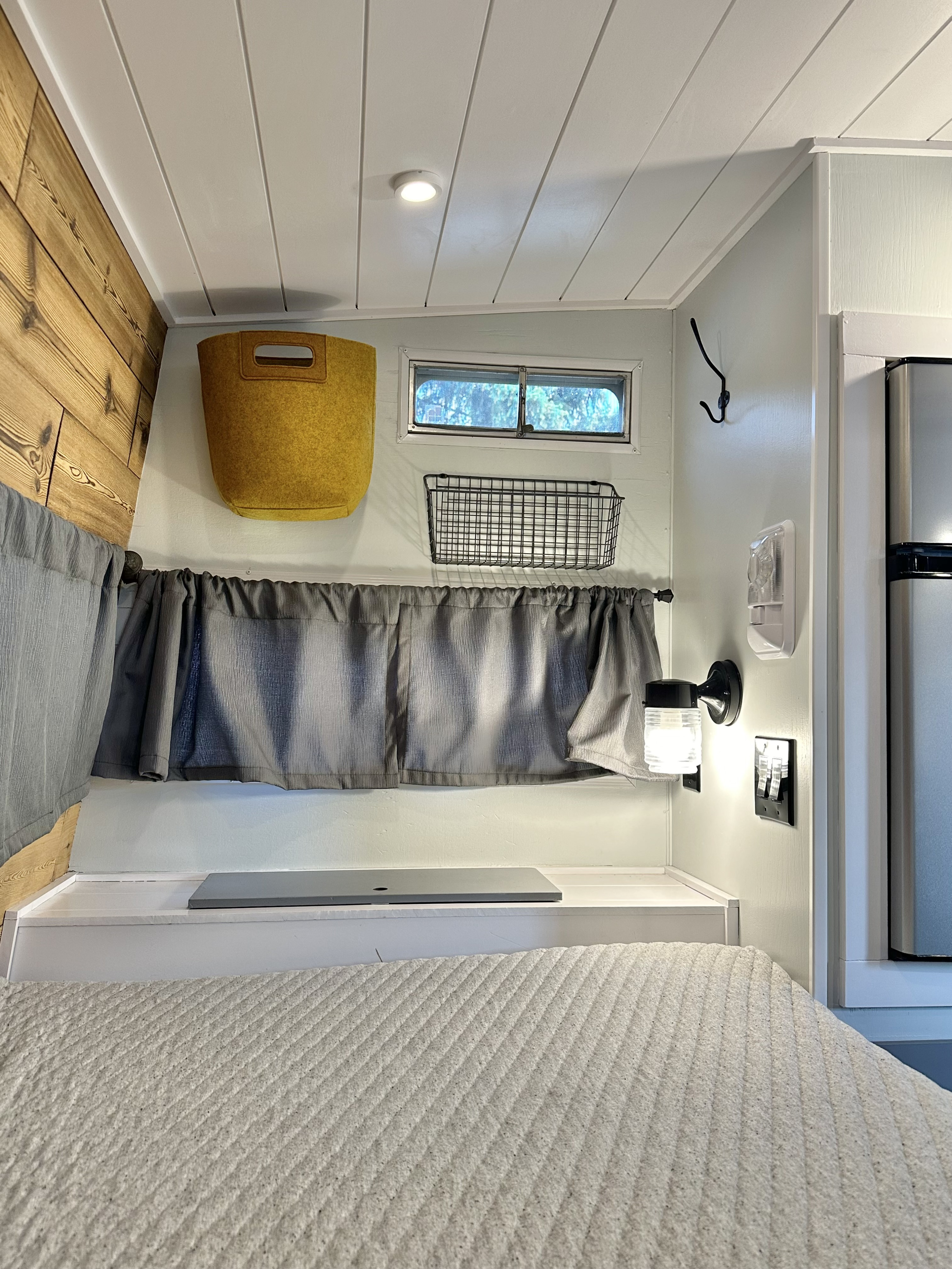 Bright, well-designed RV rental interior: bed, wood accents, smart storage & modern lighting for a cozy stay.. Cabin Trailer Skipper 1976