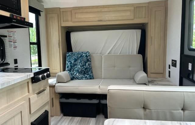 Explore this RV rental's clever interior: sofa with hidden bed, kitchen, and ample storage solutions.. Forest River Salem FSX 2023