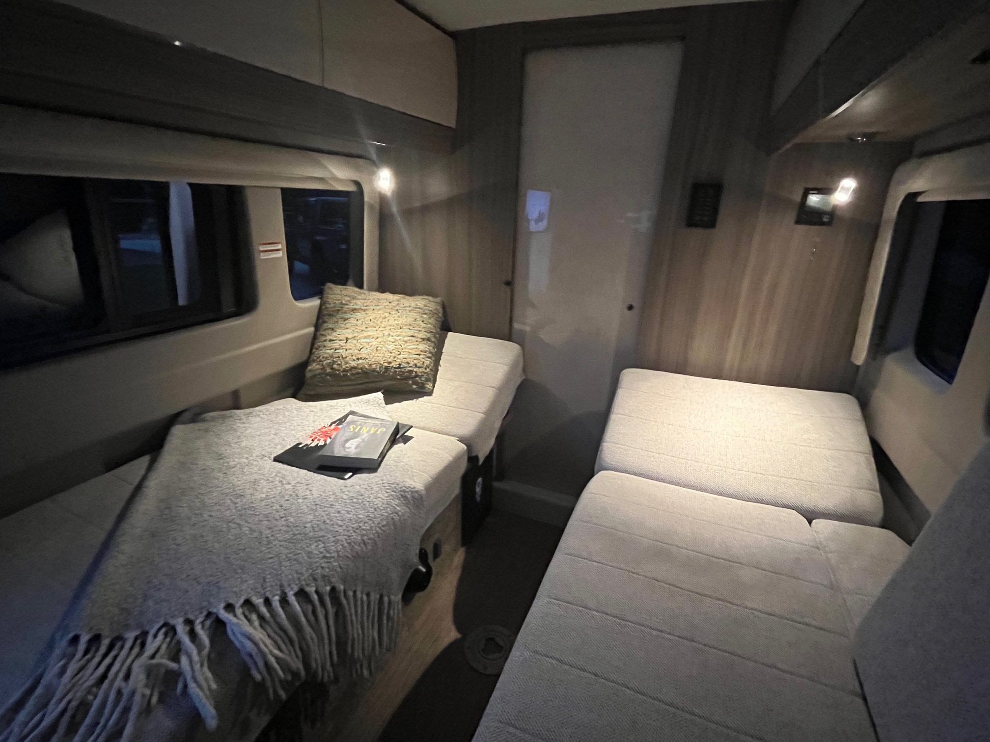Cozy RV rental interior featuring versatile seating areas, convertible to beds, ideal for travel.. Entegra Coach Ethos 2023
