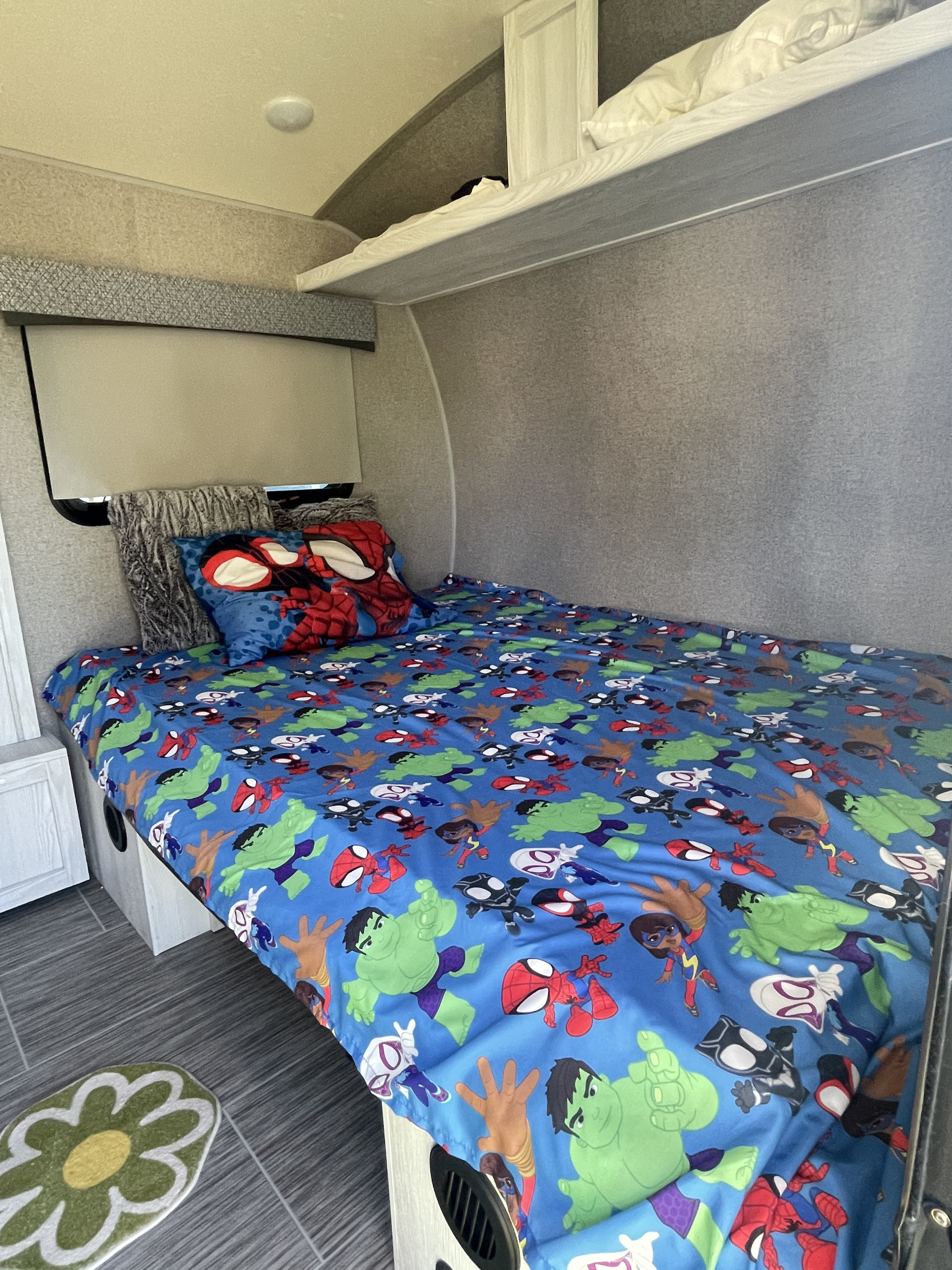 RV rental: Kids' bunkhouse featuring a vibrant Marvel-themed bed, Spider-Man pillow, and overhead bunk. Cozy & fun!. Forest River Rockwood Geo Pro 2018