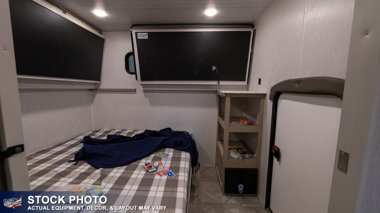 RV rental interior: cozy bedroom with two wall-mounted TVs, a comfortable bed, and shelving for a great trip.. Forest River Wildwood Platinum 2024