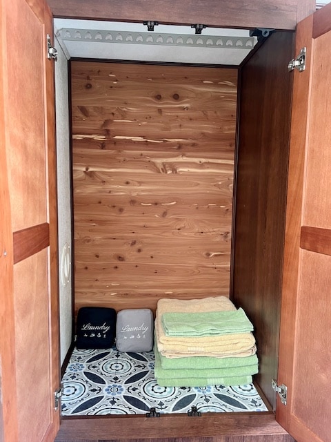 This RV rental features a cedar wardrobe with a hanging rack, laundry bags, and neatly folded towels for organized storage.. Forest River Forester 3051S 2018