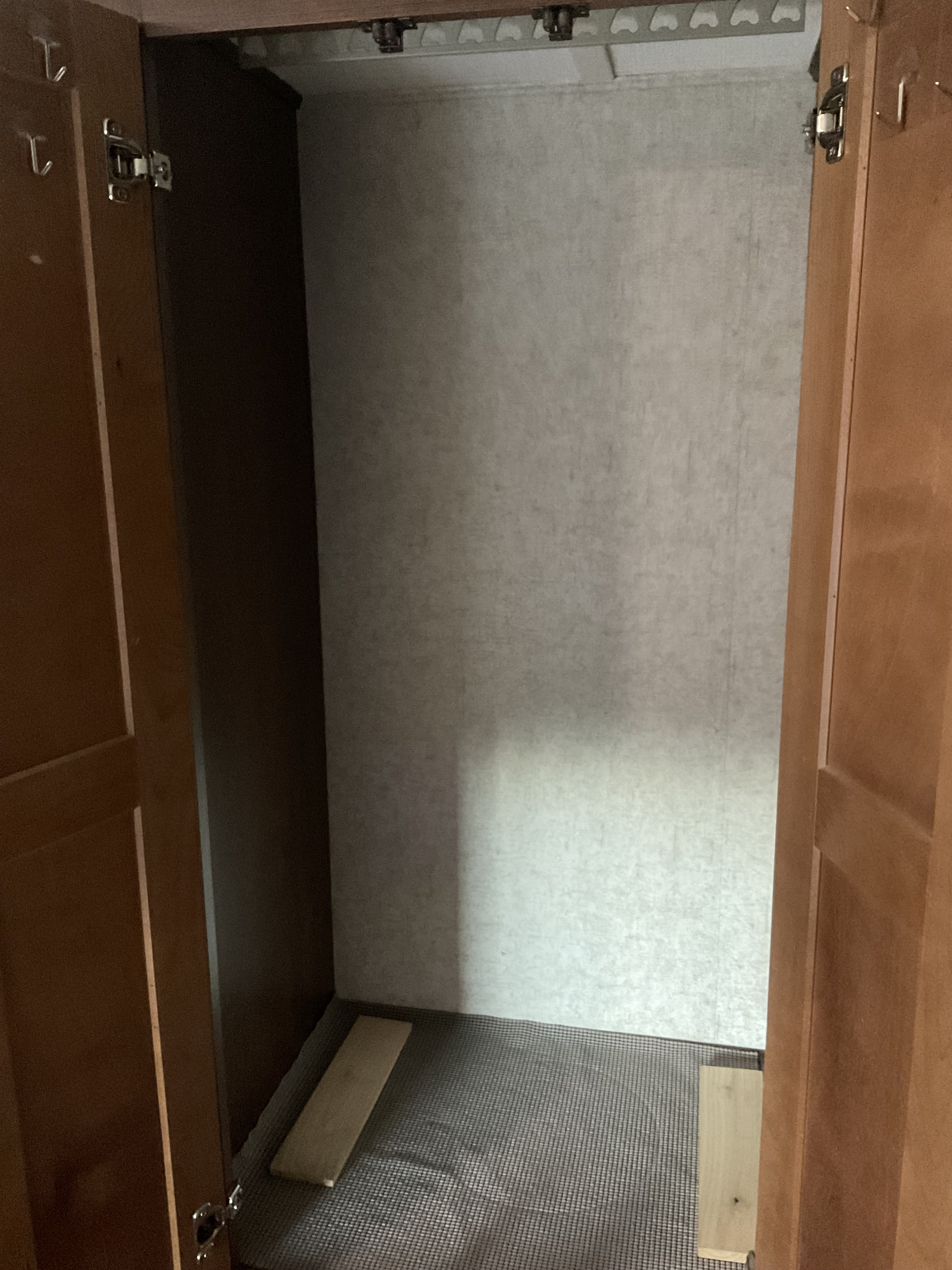 Inside an RV rental closet, featuring a hanger rack, textured walls, and compact storage space.. Forest River Sunseeker 2019