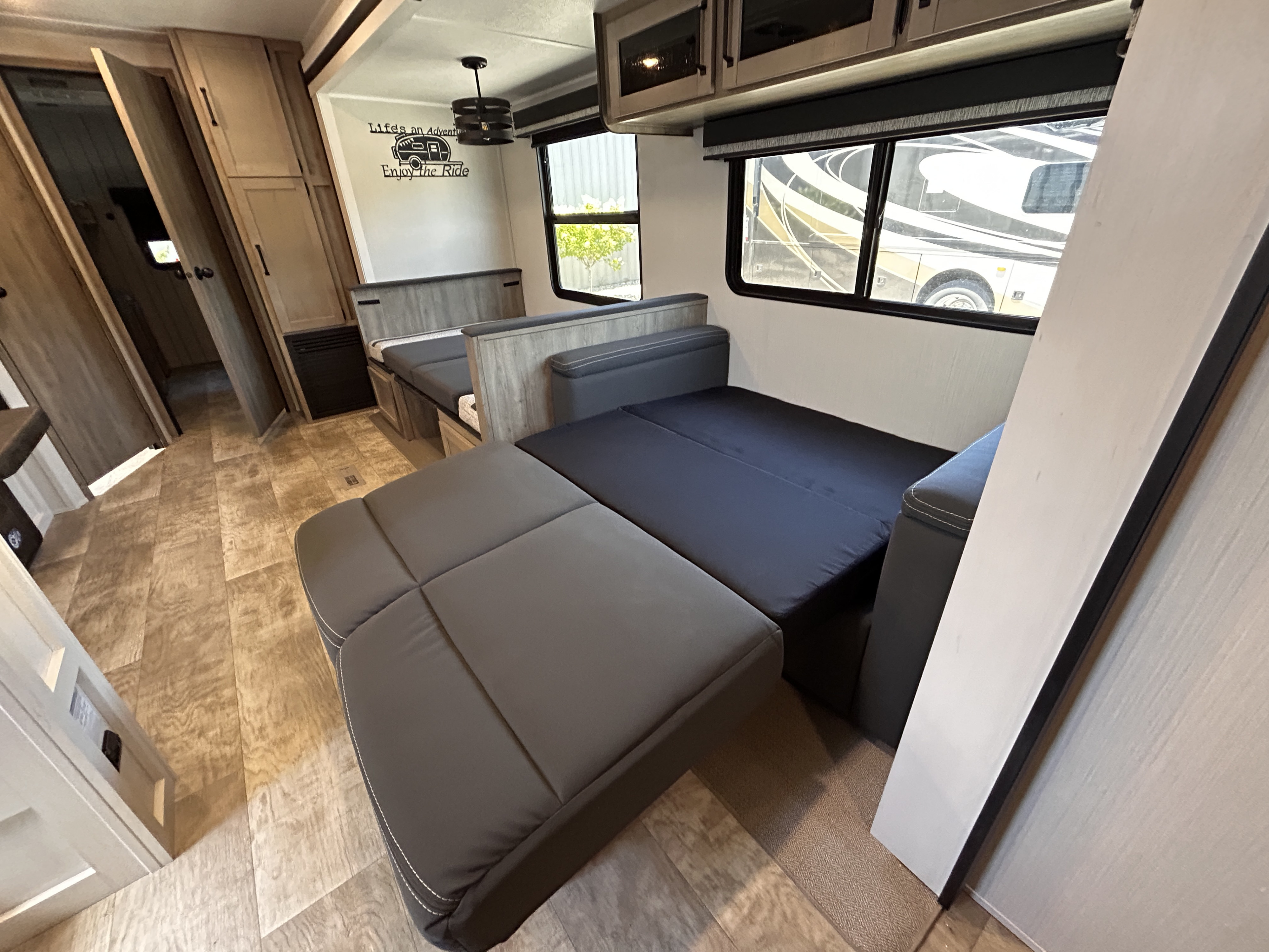 This RV rental interior shows a flexible living space with modular seating and a convertible bed, ideal for road trip adventures.. Palomino Puma 2024