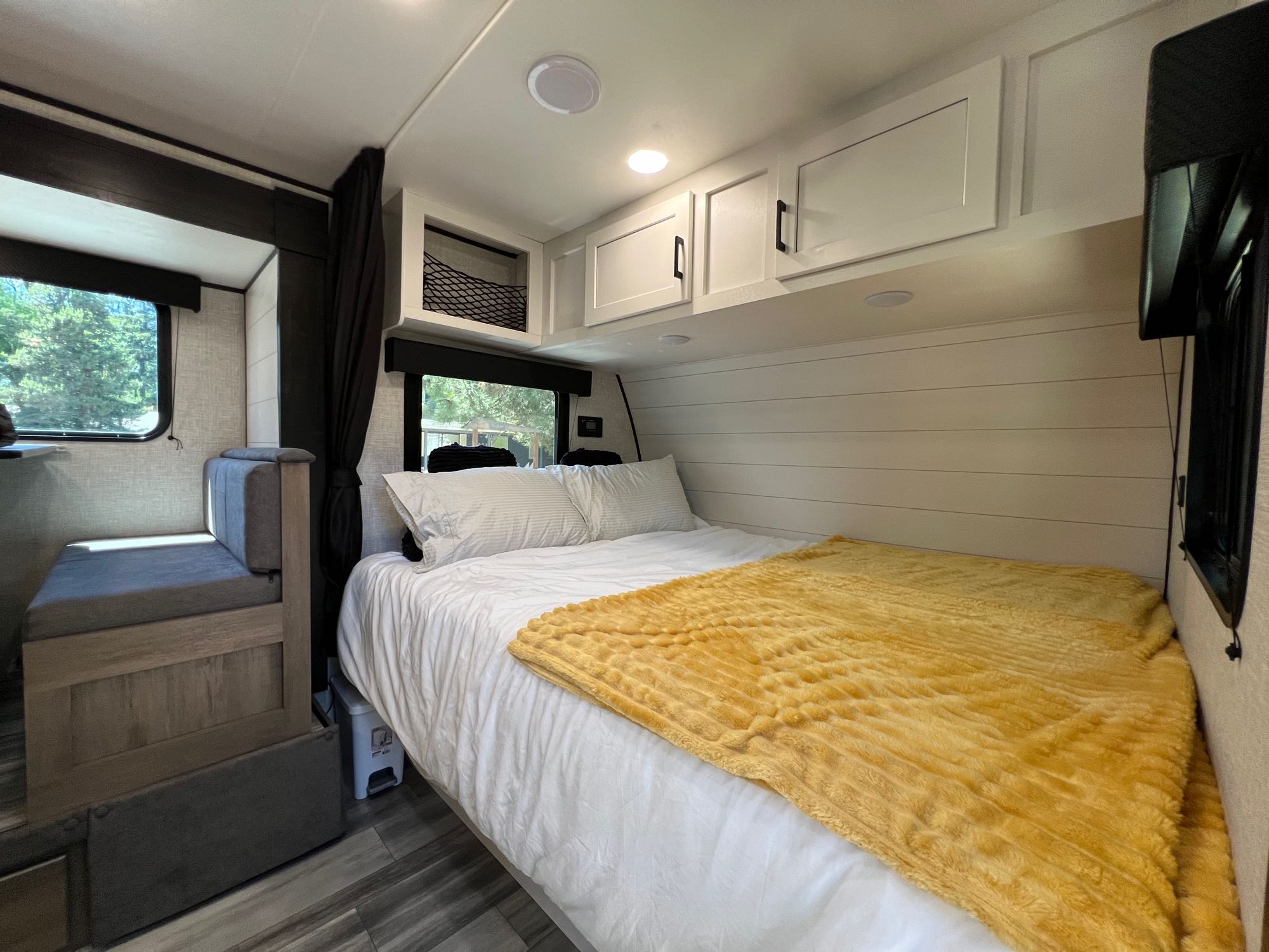 This inviting RV rental interior features a comfy bed, dinette, and overhead storage, creating a functional living space.. Jayco Jay Flight SLX Baja Edition 2024