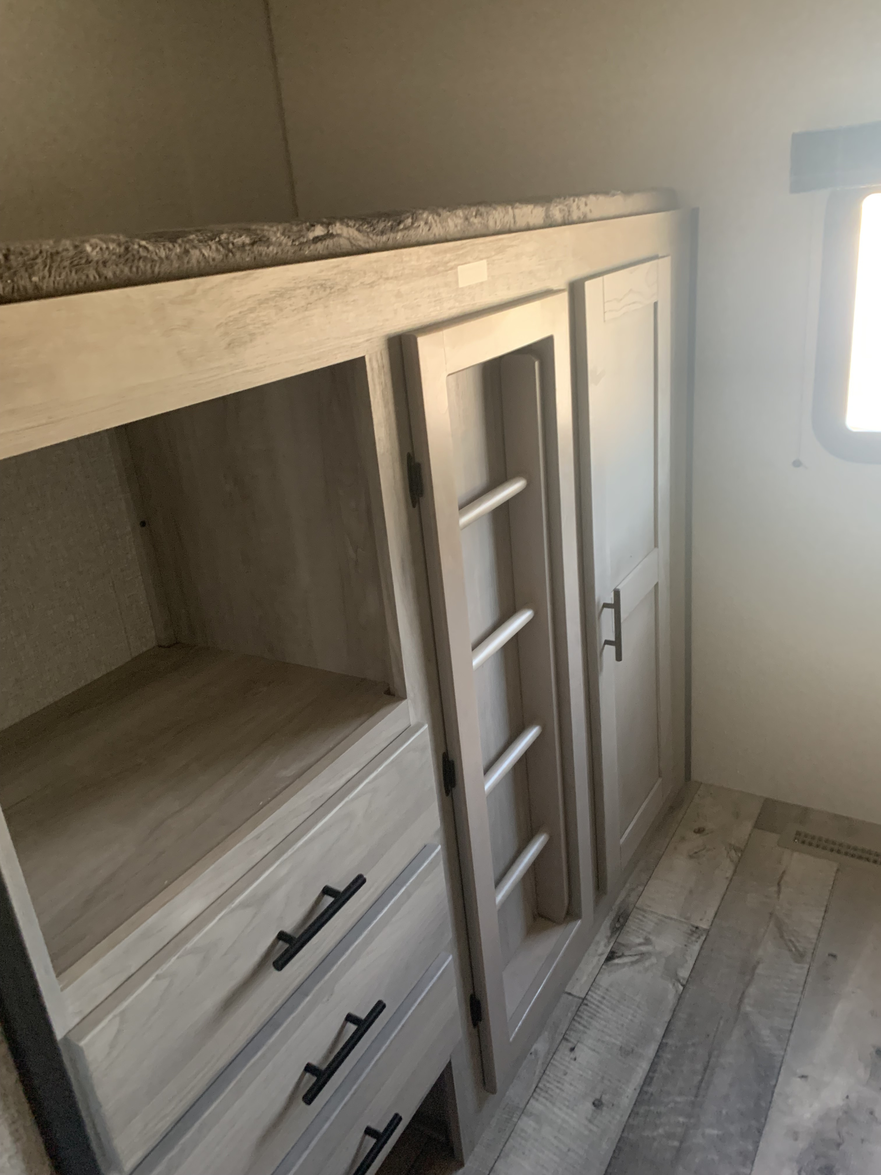 RV rental: Cozy bunk bed with light wood built-in storage, drawers, and ladder. Perfect for trips!. Connect C322BHK 2022
