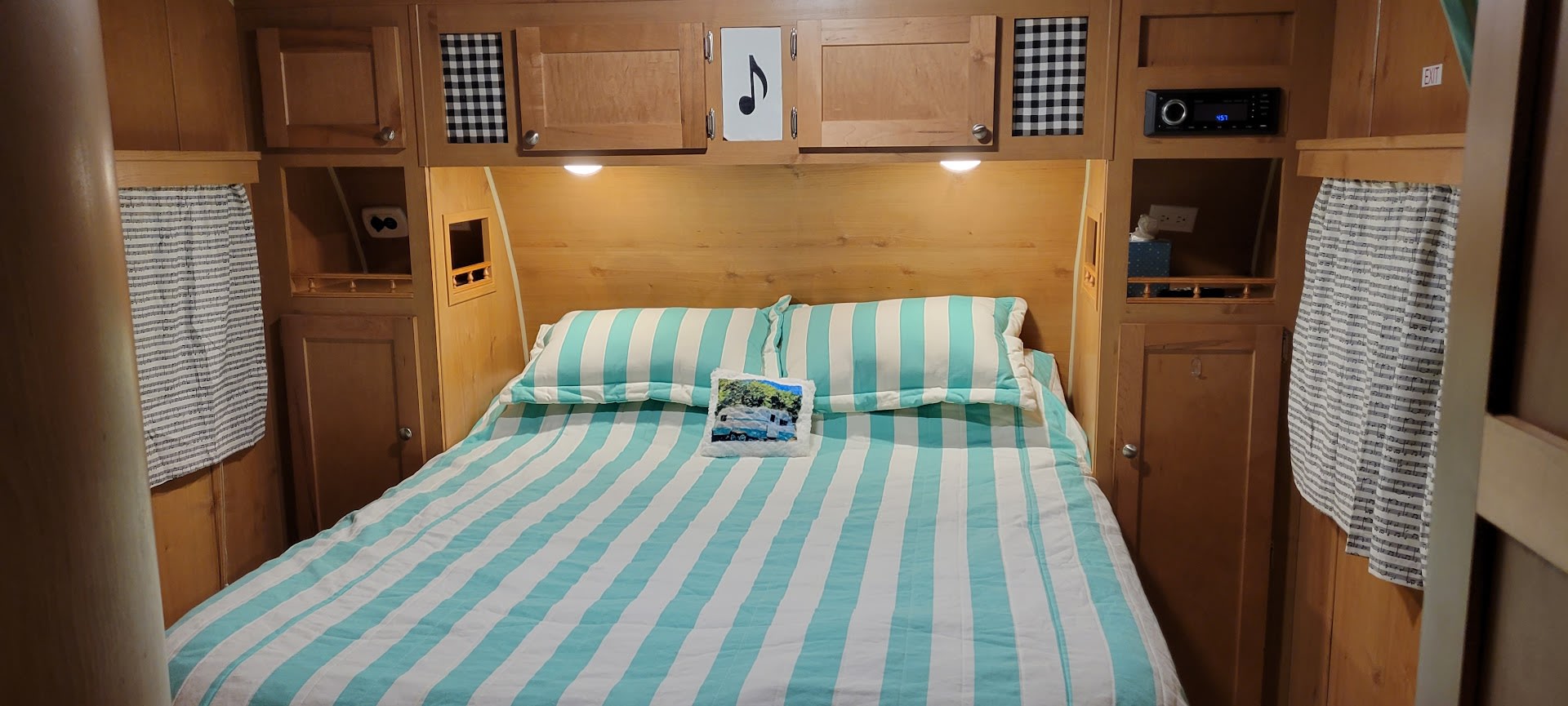 Your private bedroom features a comfy queen bed, TCL Google Smasrt TV with Google remote, TV remote, ceiling and overhead lighting as well as side night lights with overhead, underbed and side storage. Just roll your luggage neatly into the side cupboards! . Riverside RV Retro 2019