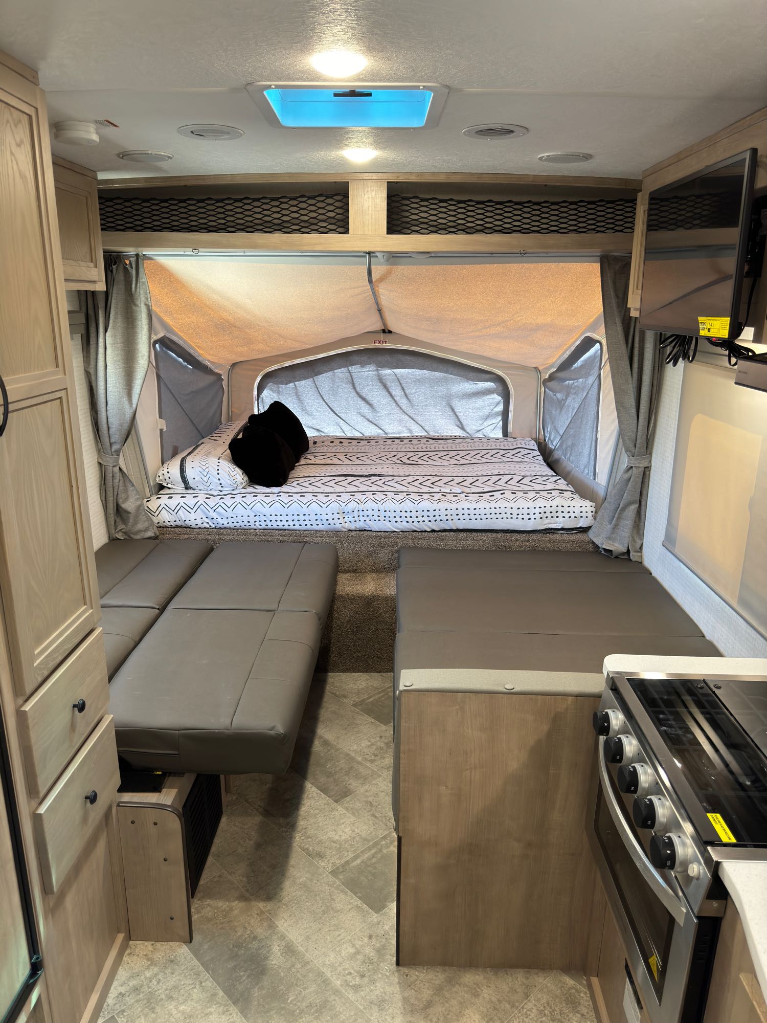 RV rental interior: cozy hybrid trailer with a large bed, convertible dinette, and kitchen for your next adventure.. Forest River Palomino Solaire 2023