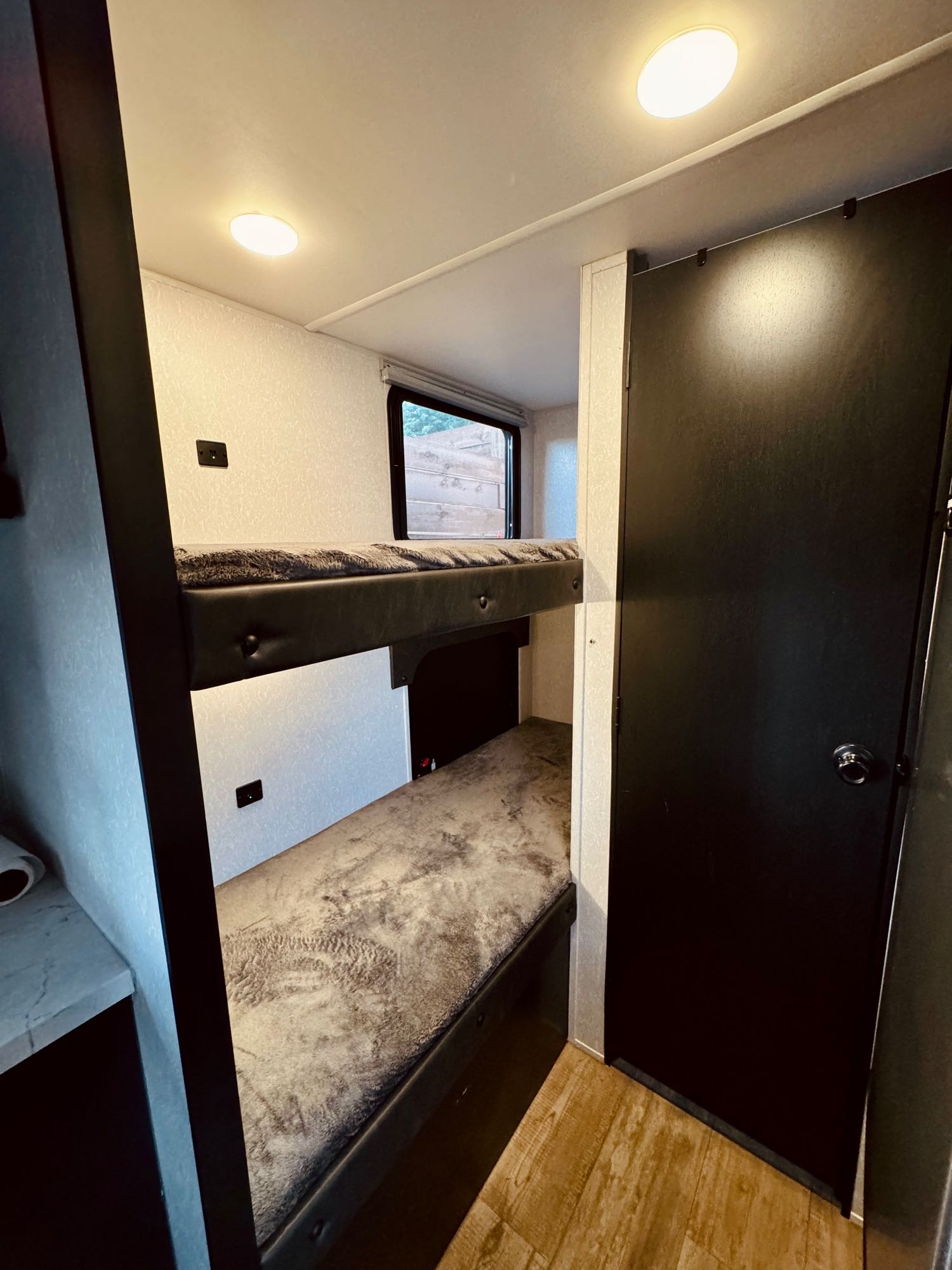 Twin-sized bunk beds with USB chargers built in. Bottom bunk folds up for additional storage space. . Forest River Cherokee Wolf Pup 2022