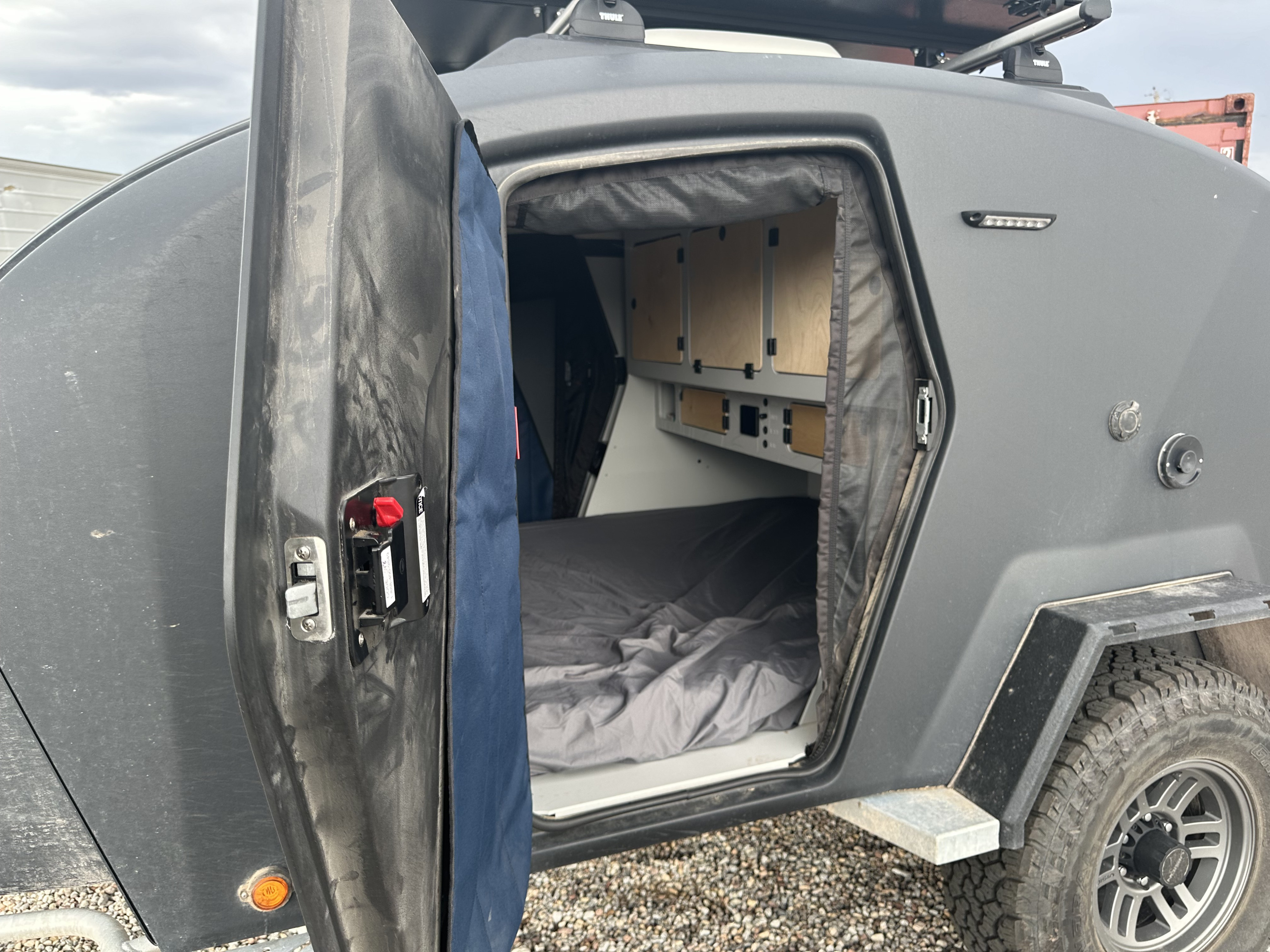 Inside this rugged RV rental: a comfy camper trailer bed and built-in storage.. Escapod Escapod Trailer 2023