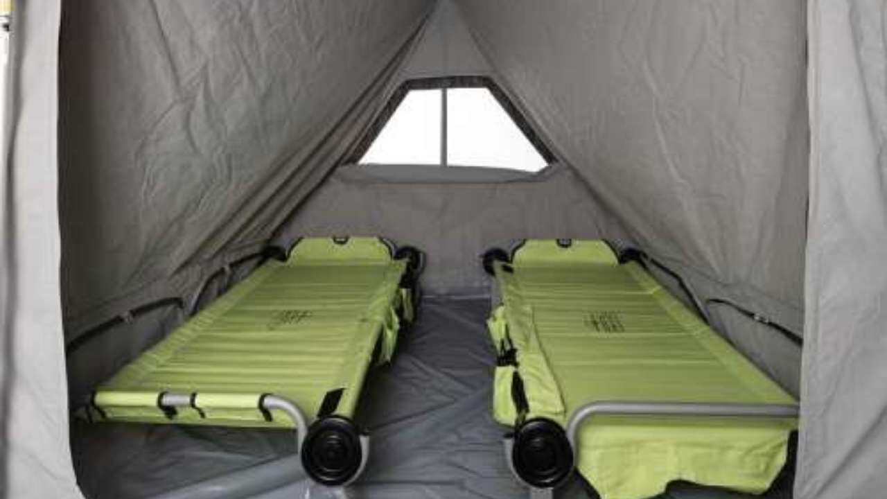 RV rental interior shows two lime green cots in a grey tent-like camper, offering a comfortable sleeping area.. Patriot Campers Patriot Campers Trailer 2022