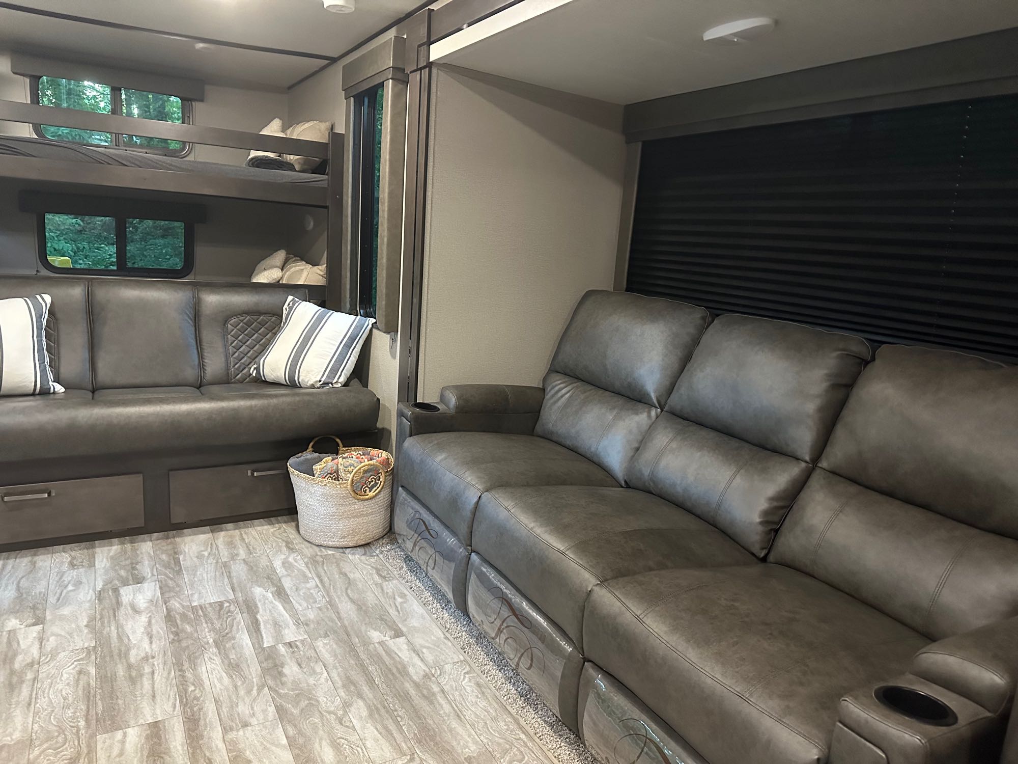 Cozy RV rental interior featuring comfortable bunk beds and plush sofas, perfect for family adventures on the road.. Grand Design Transcend Xplor 2022