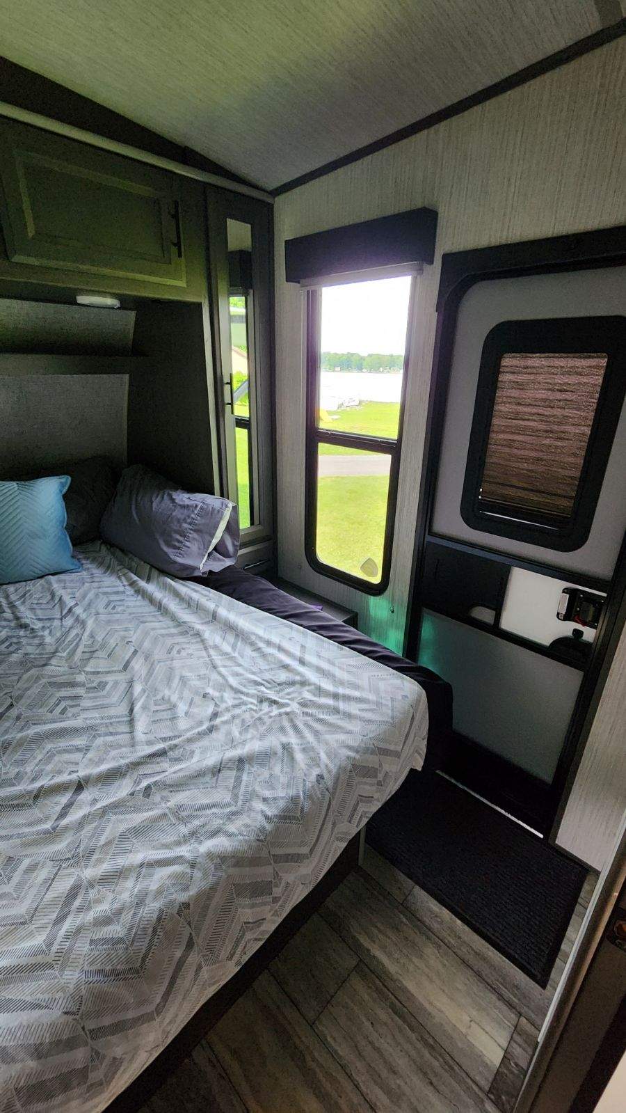 Cozy RV rental bedroom with a view of the lake, perfect for a relaxing travel experience.. Heartland Fuel 305 2020