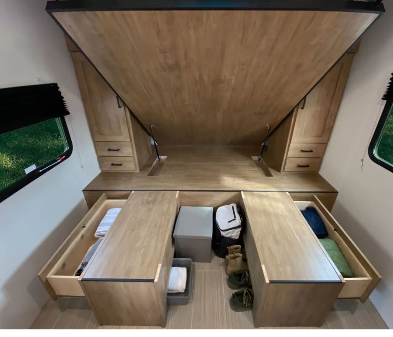 This RV rental bedroom features smart storage: the bed folds up, revealing pull-out drawers and compartments for maximizing space.. Coachmen fet257bhs-320 2021