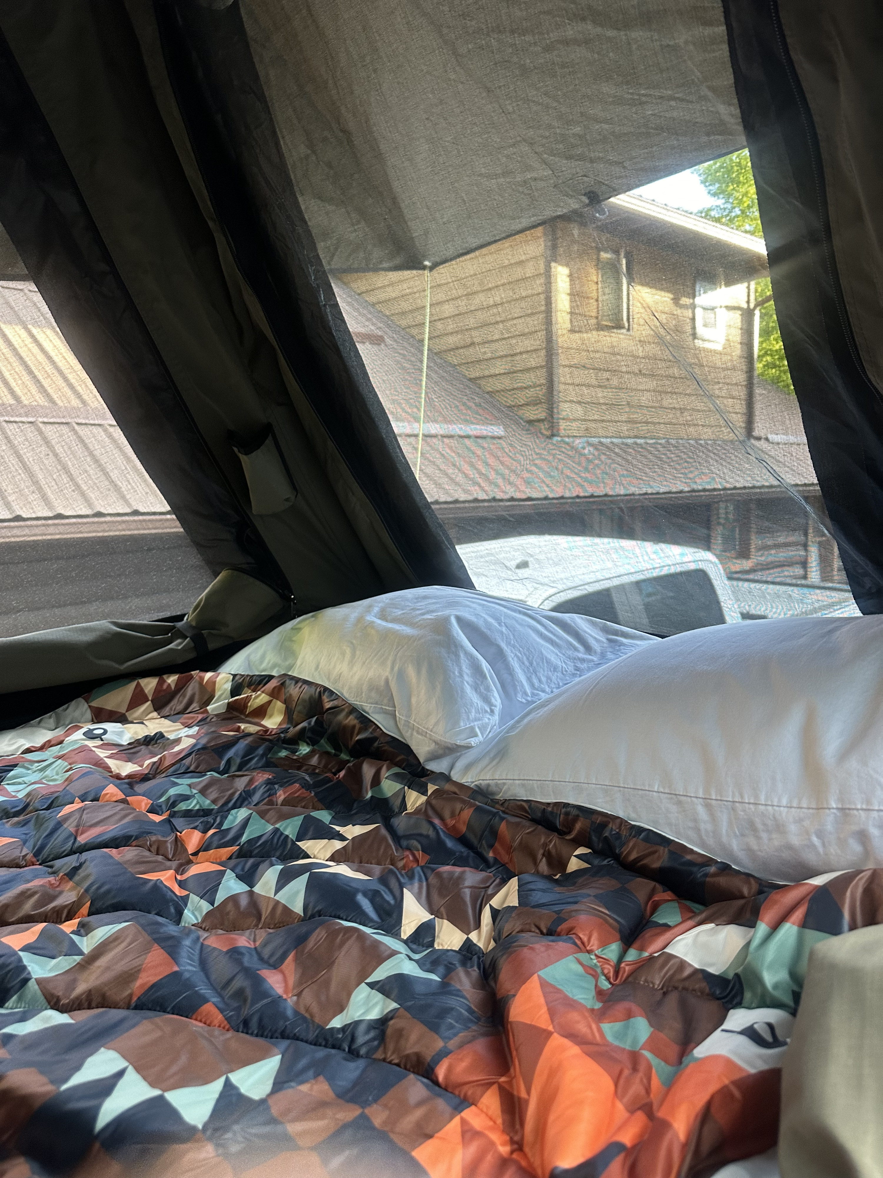 An RV rental's cozy rooftop tent interior. Features a comfy bed & scenic view, ideal for glamping.. Ford Ford F150 2013