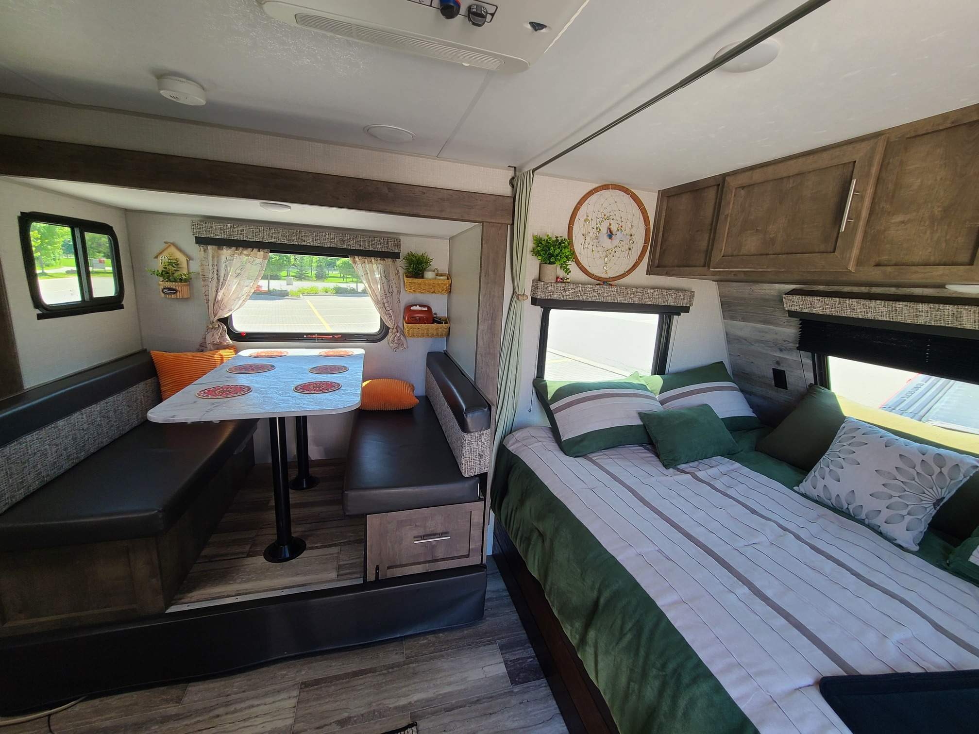 Cozy RV rental interior featuring a dinette, comfortable bed, and ample storage. Perfect for your next adventure!. KZ Escape 2020