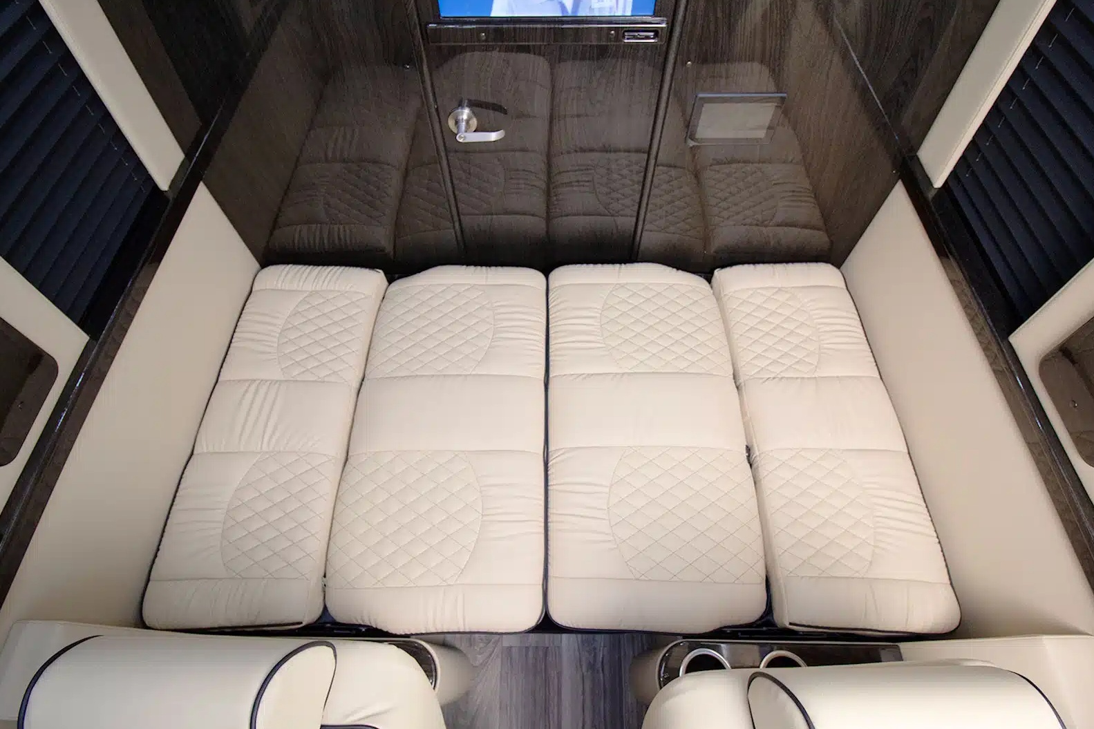 RV rental: View of a luxurious sleeping area with four quilted white mattress sections inside the cabin.. Ultimate Toys Ultimate Coach 2025