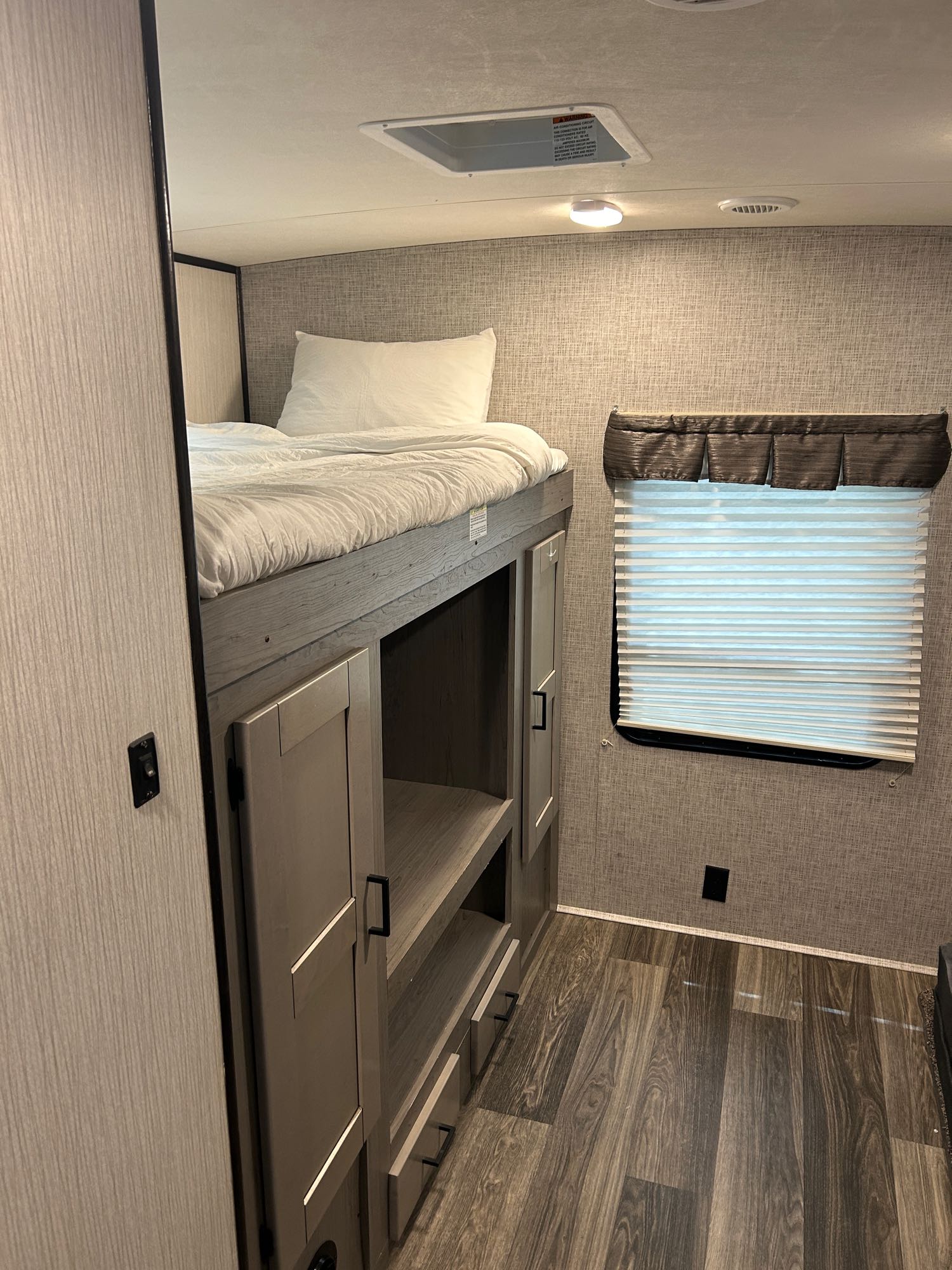 RV rental bedroom with comfortable bunk beds, built-in storage, and a window.. Heartland RVs Mallard 2020